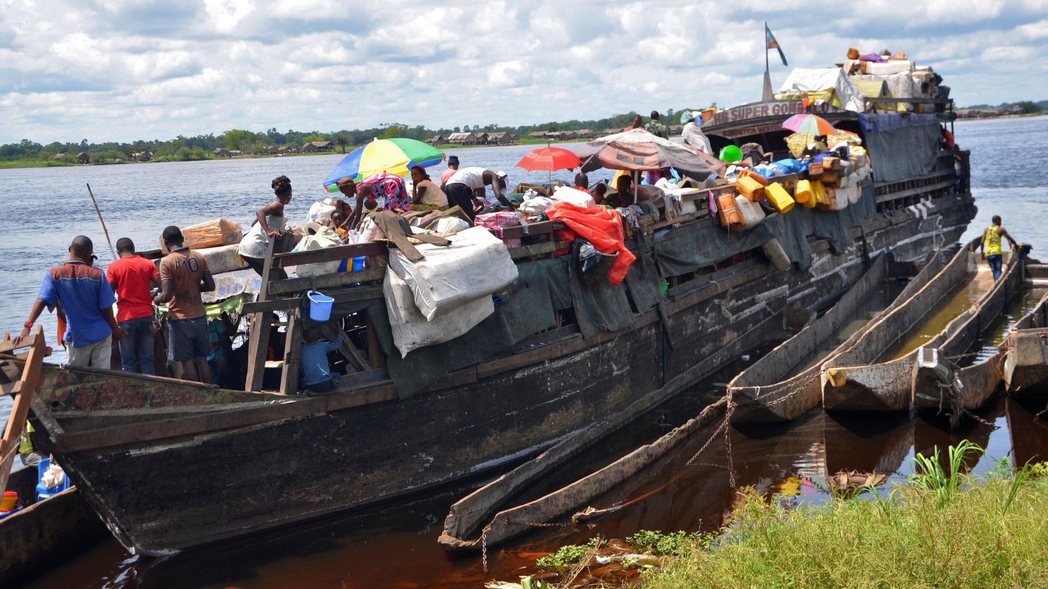 A barge on the Congo river filled with passengers and cargo