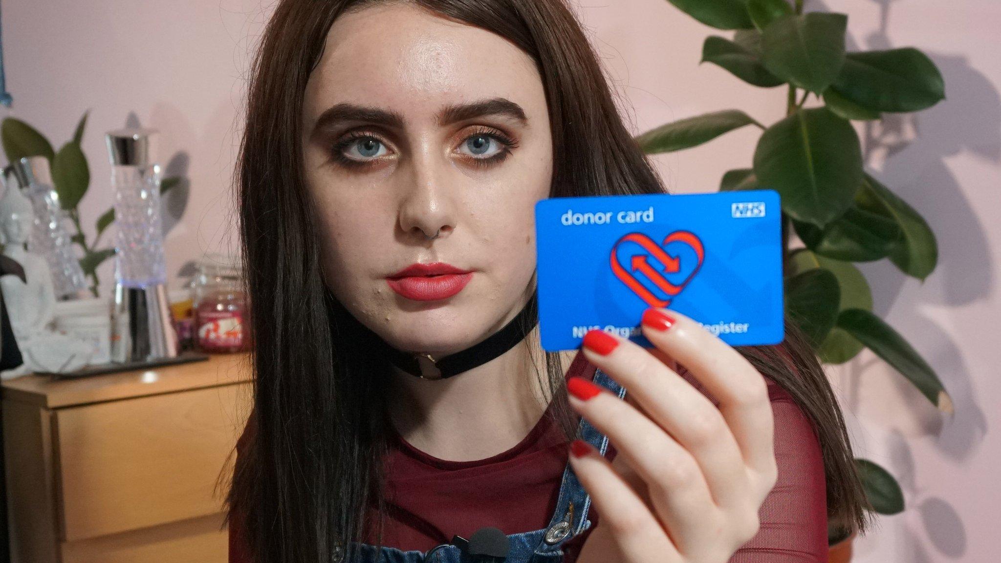 Rachel holding her donor card