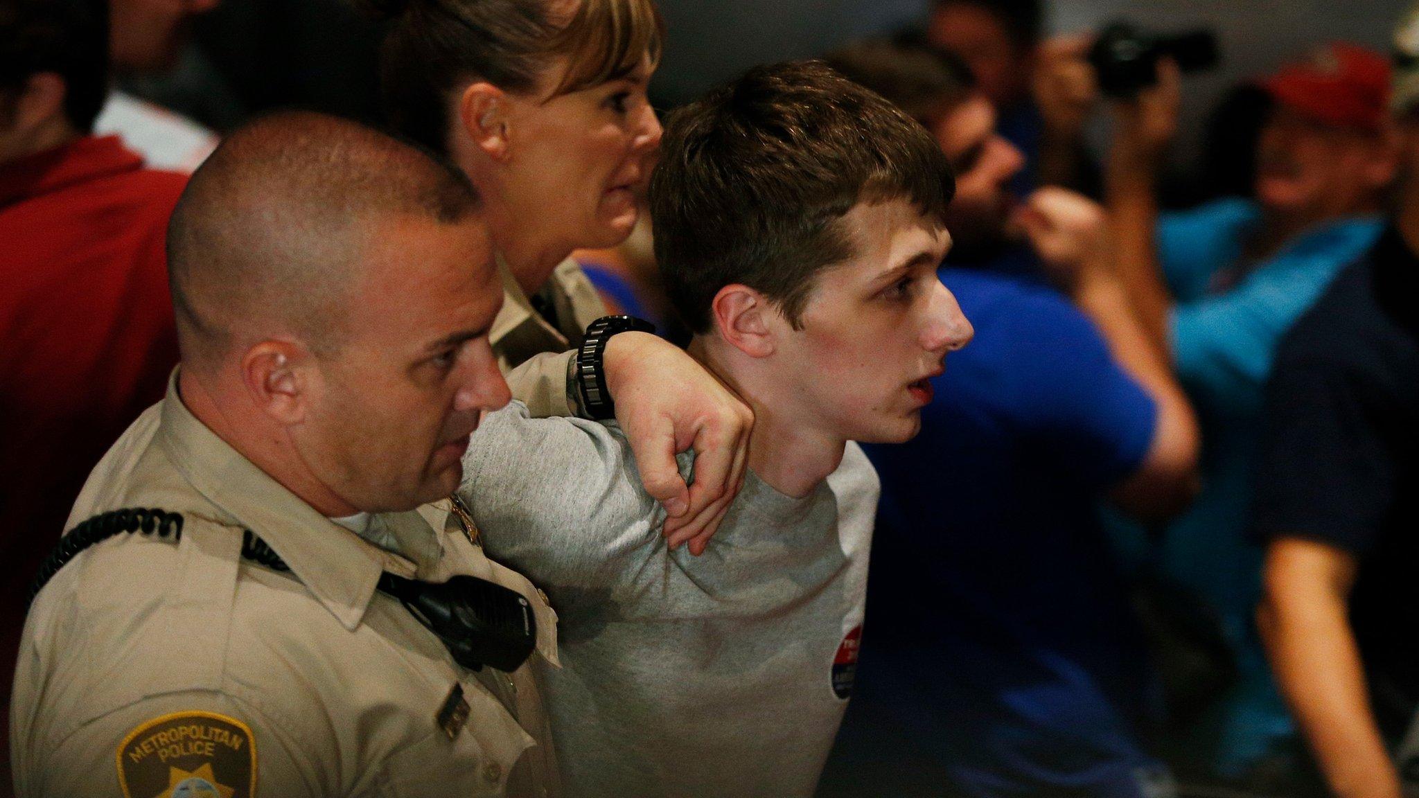 Police remove protestor Michael Steven Sandford as Republican presidential candidate Donald Trump speaks at the Treasure Island hotel and casino in Las Vegas