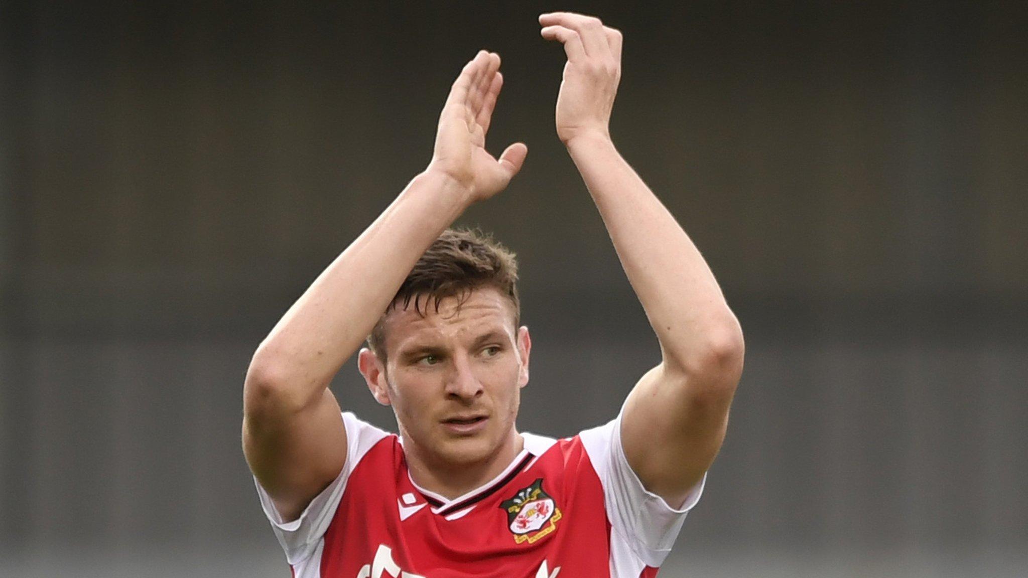 Wrexham striker Paul Mullin applauds supporters