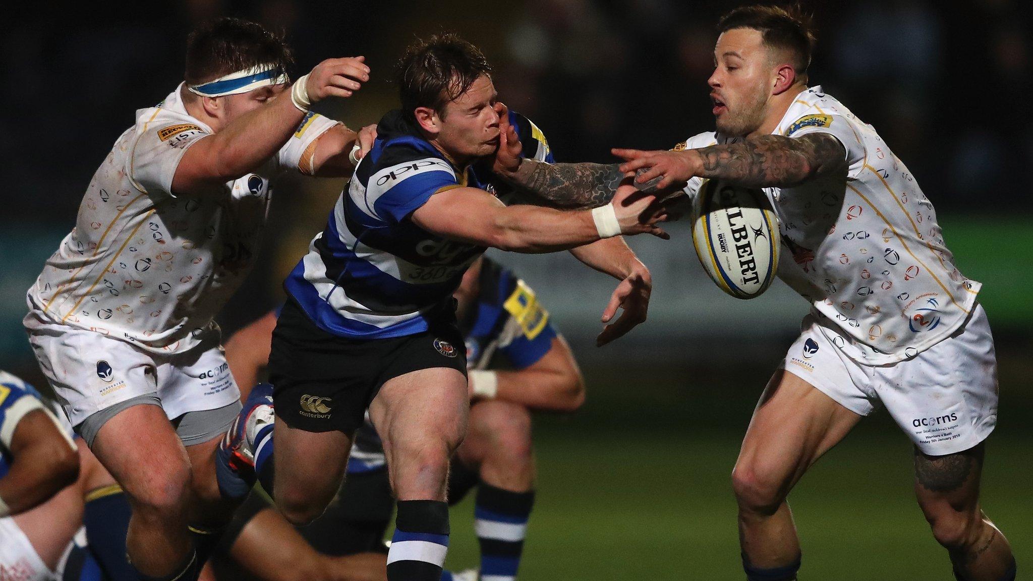 Bath scrum-half Chris Cook offloads under pressure from Worcester's Francois Hougaard