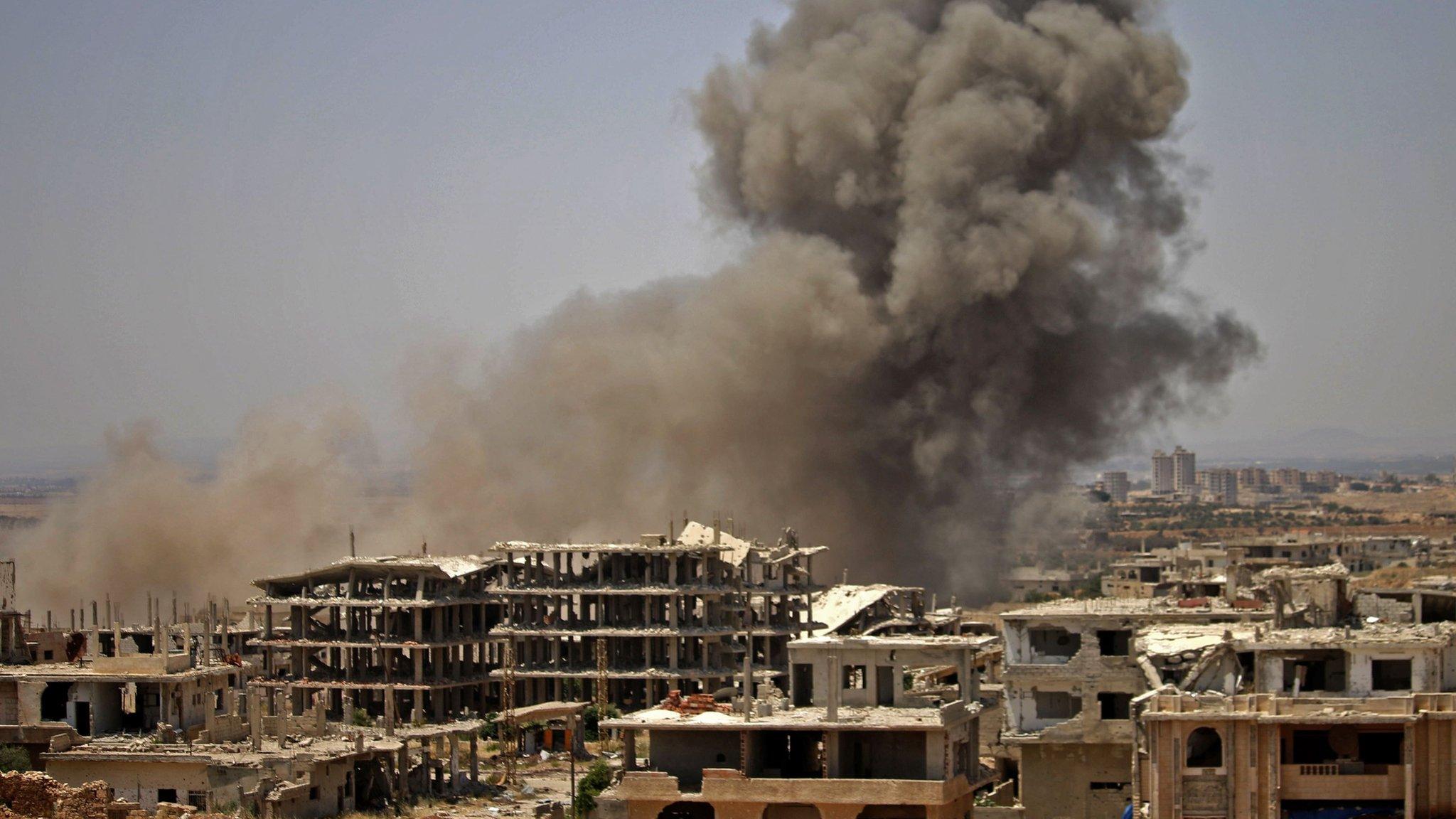 Smoke rises above a rebel-held area of Deraa after an air strike by Syrian government forces (28 June 2018)