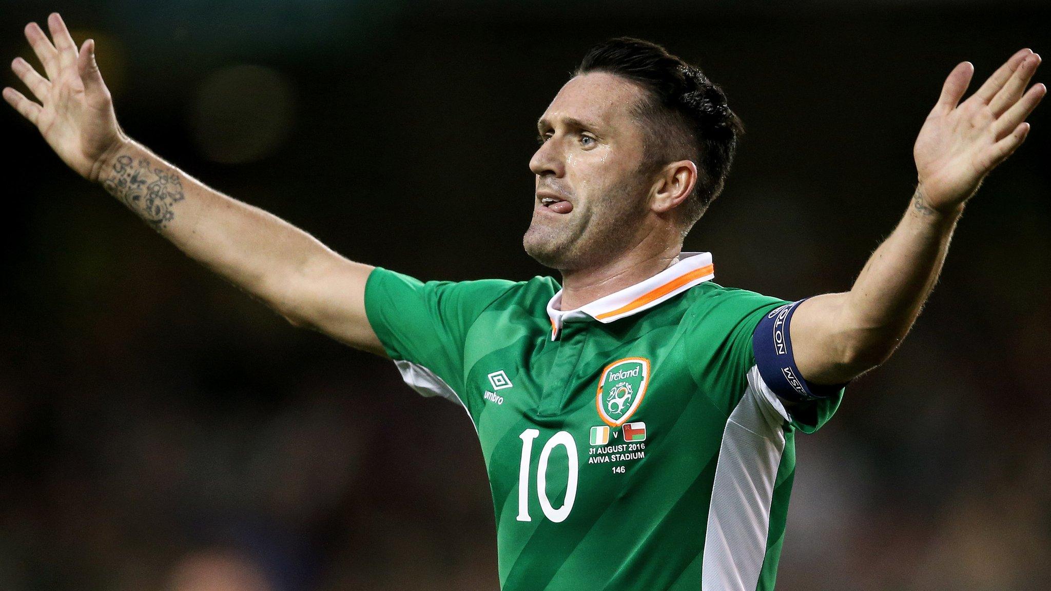 Robbie Keane celebrates scoring against Oman