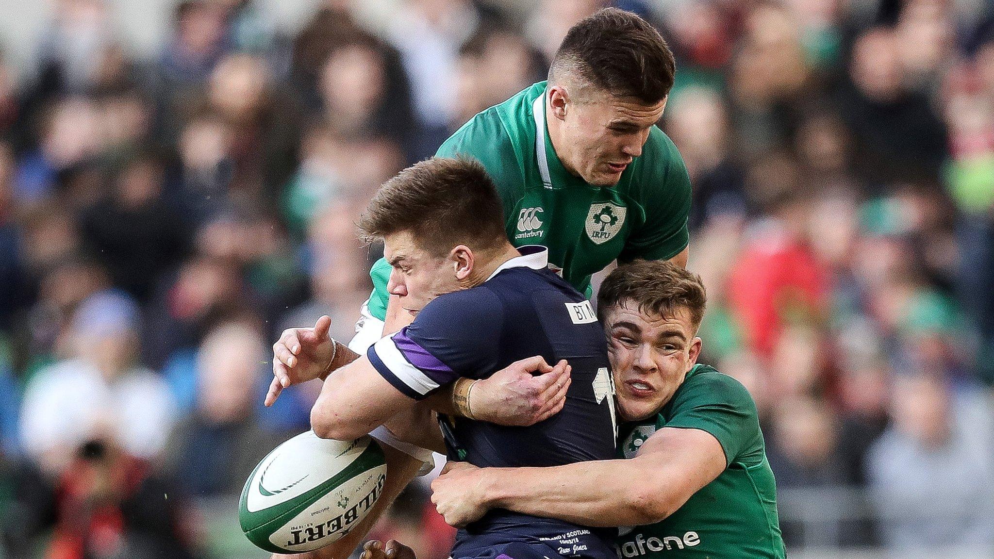 Jacob Stockdale and Garry Ringrose tackle Scotland's Huw Jones