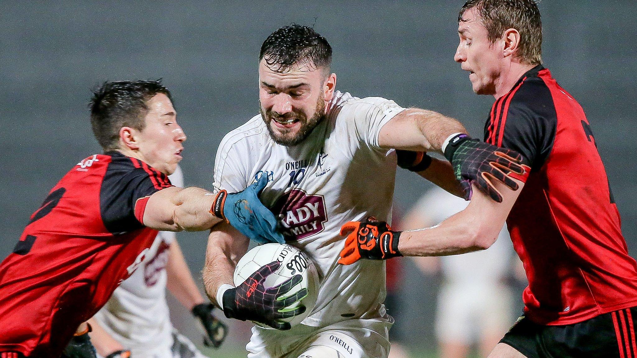 Down pair Caolan Mooney and Ryan McAleenan tackle Kildare's Fergal Conway