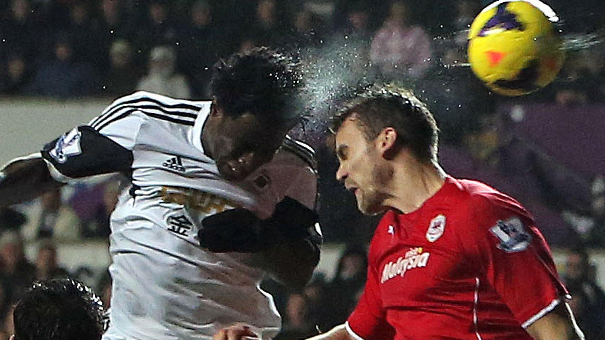 Swansea City's Wilfried Bony competes with Cardiff City's Ben Turner in the last south Wales derby