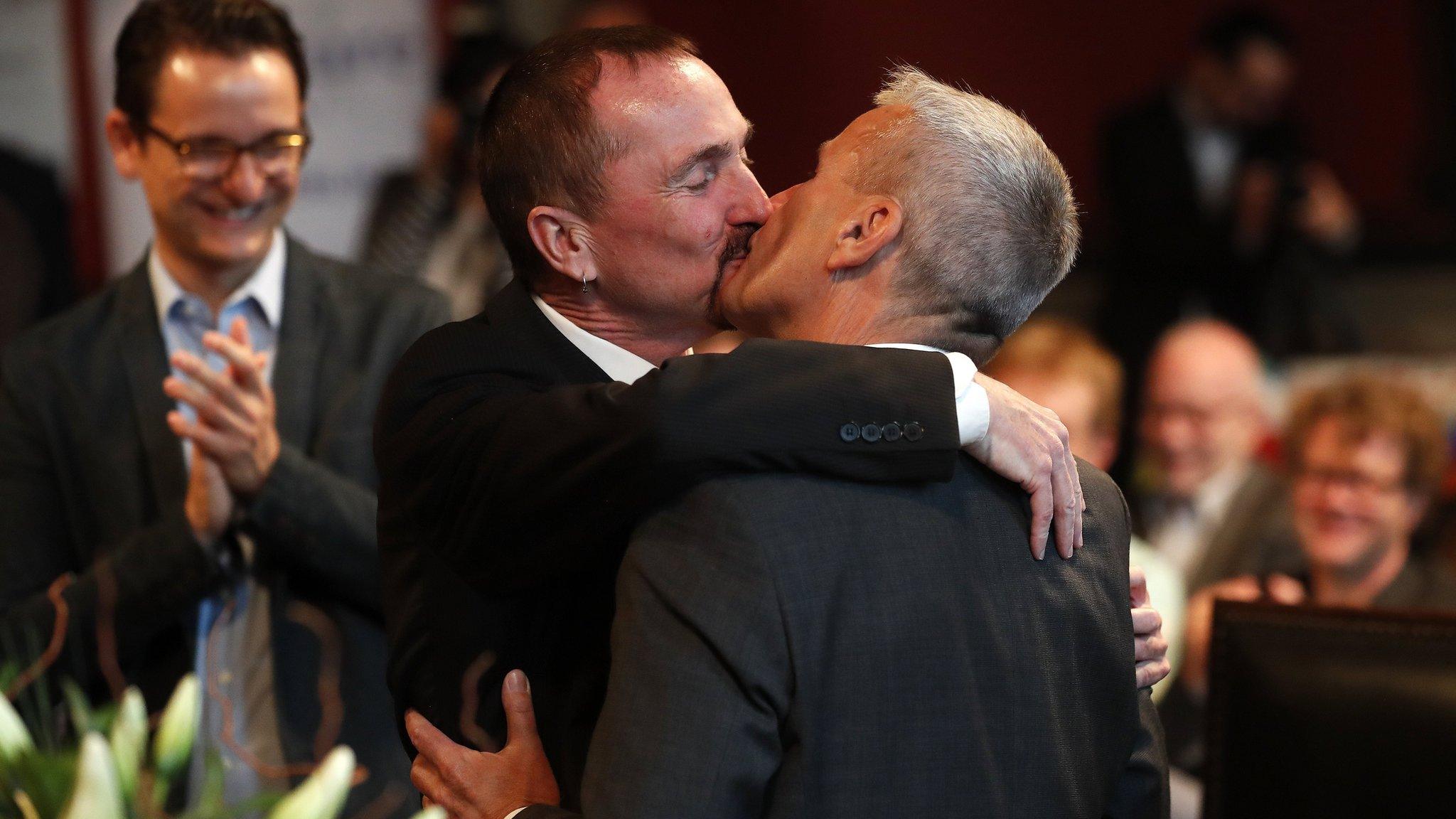 Karl Kreile (L) kisses Bodo Mende during the first civil wedding ceremony between two men in Berlin, Germany (01 October 2017)