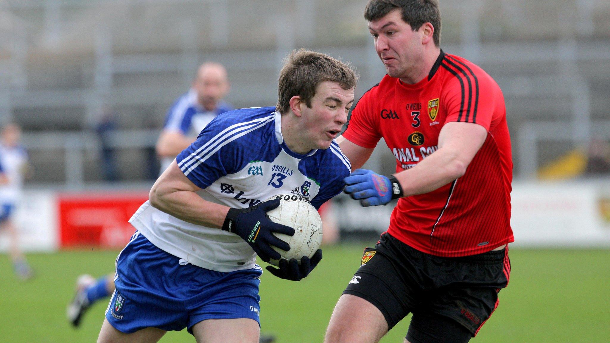 Monaghan's Jack McCarron is challenged by Peter Turley of Down