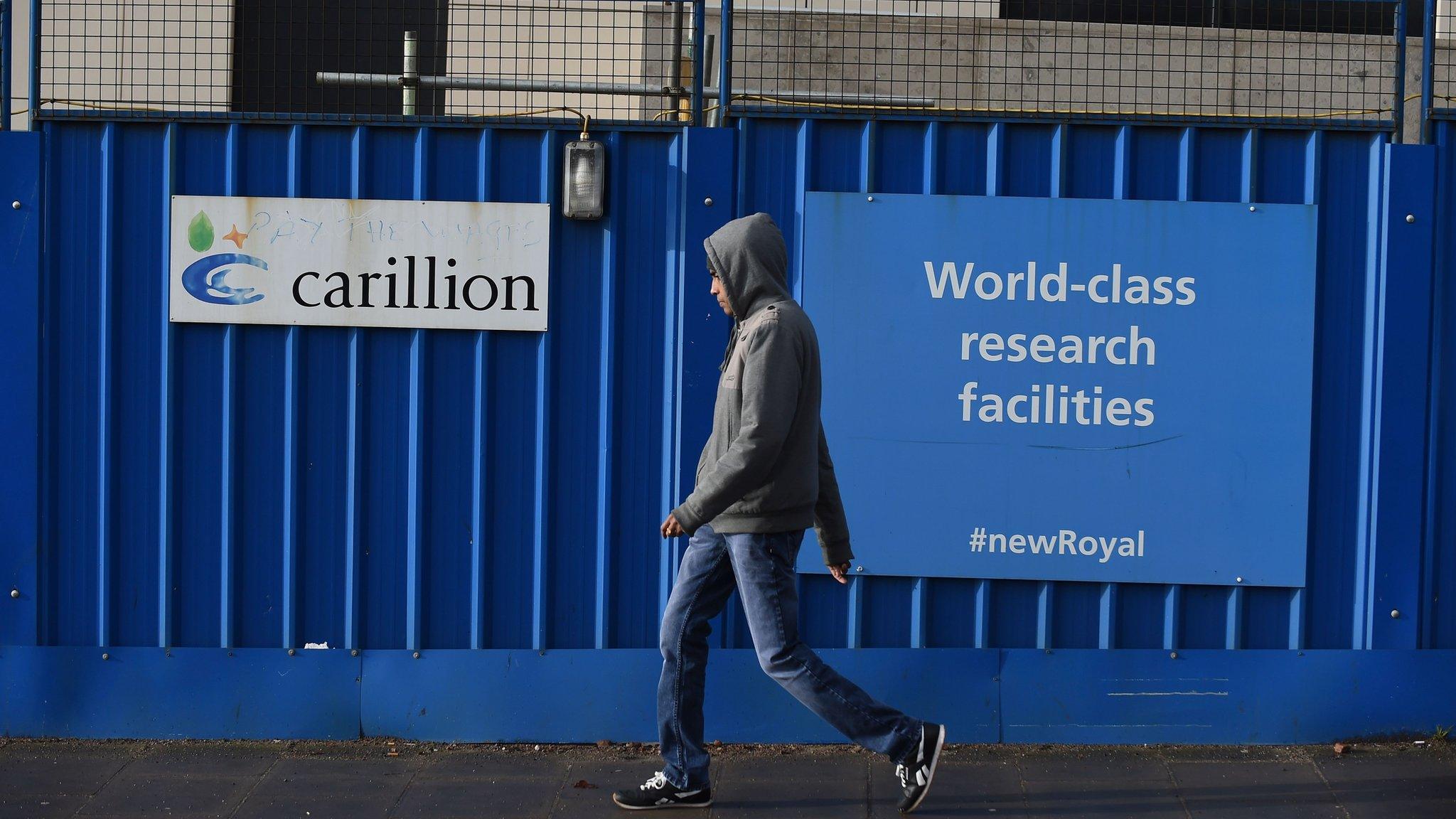 Man walks past Carillion building site