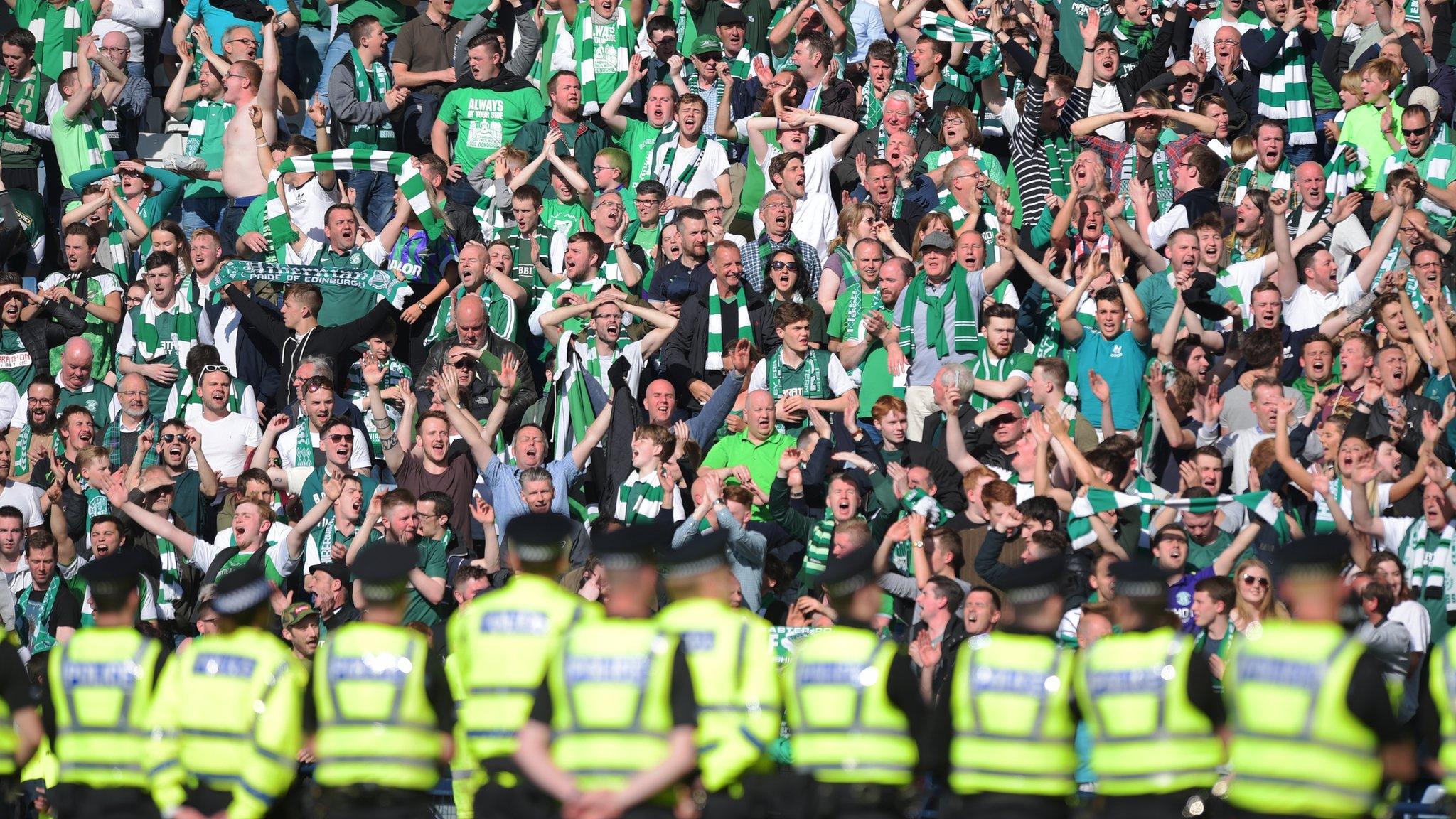 Police form a cordon on the Hampden pitch