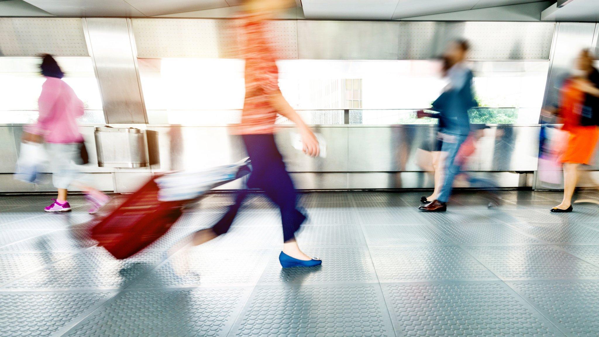 People walking through airport.