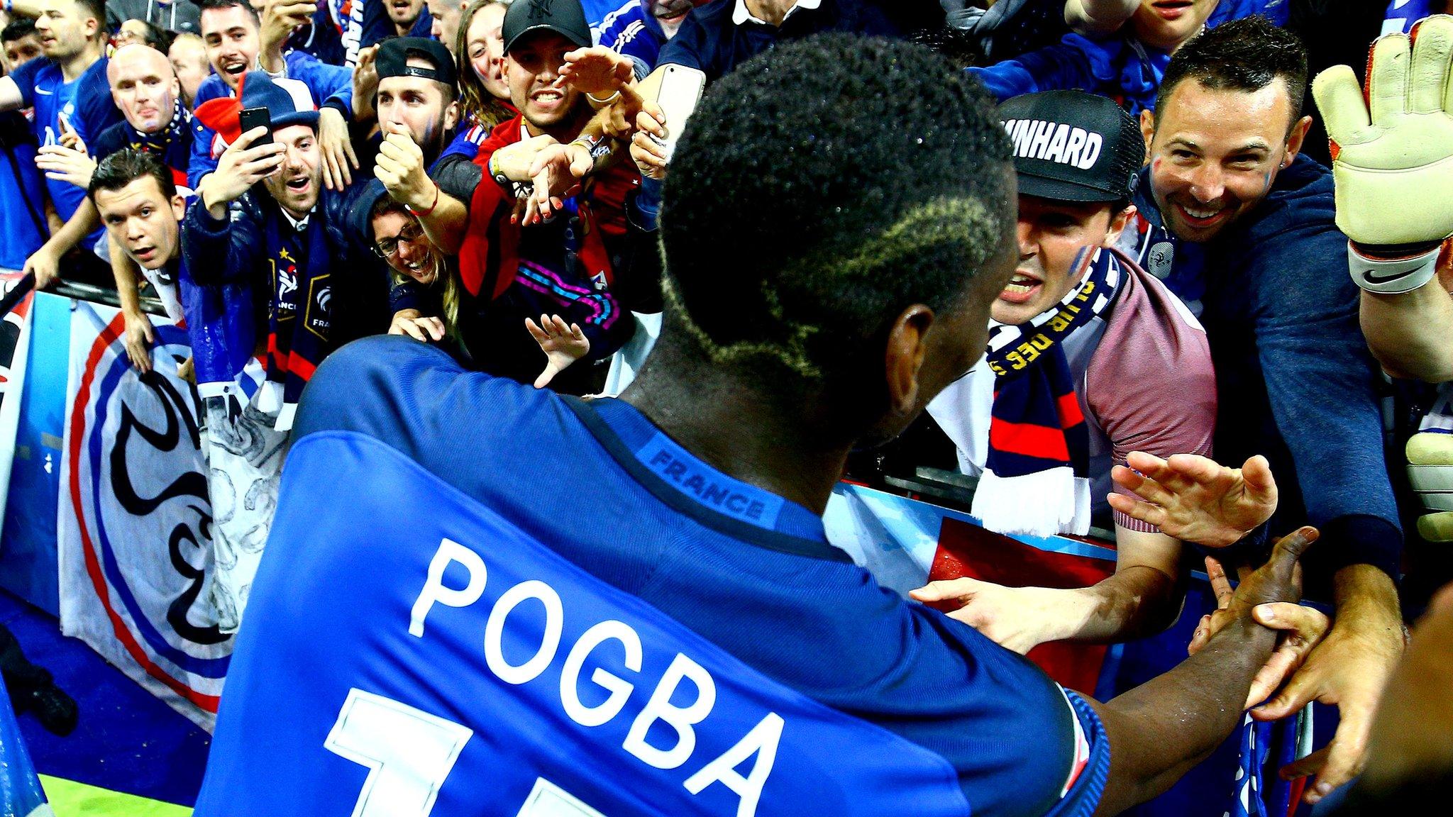 Paul Pogba celebrates with France fans