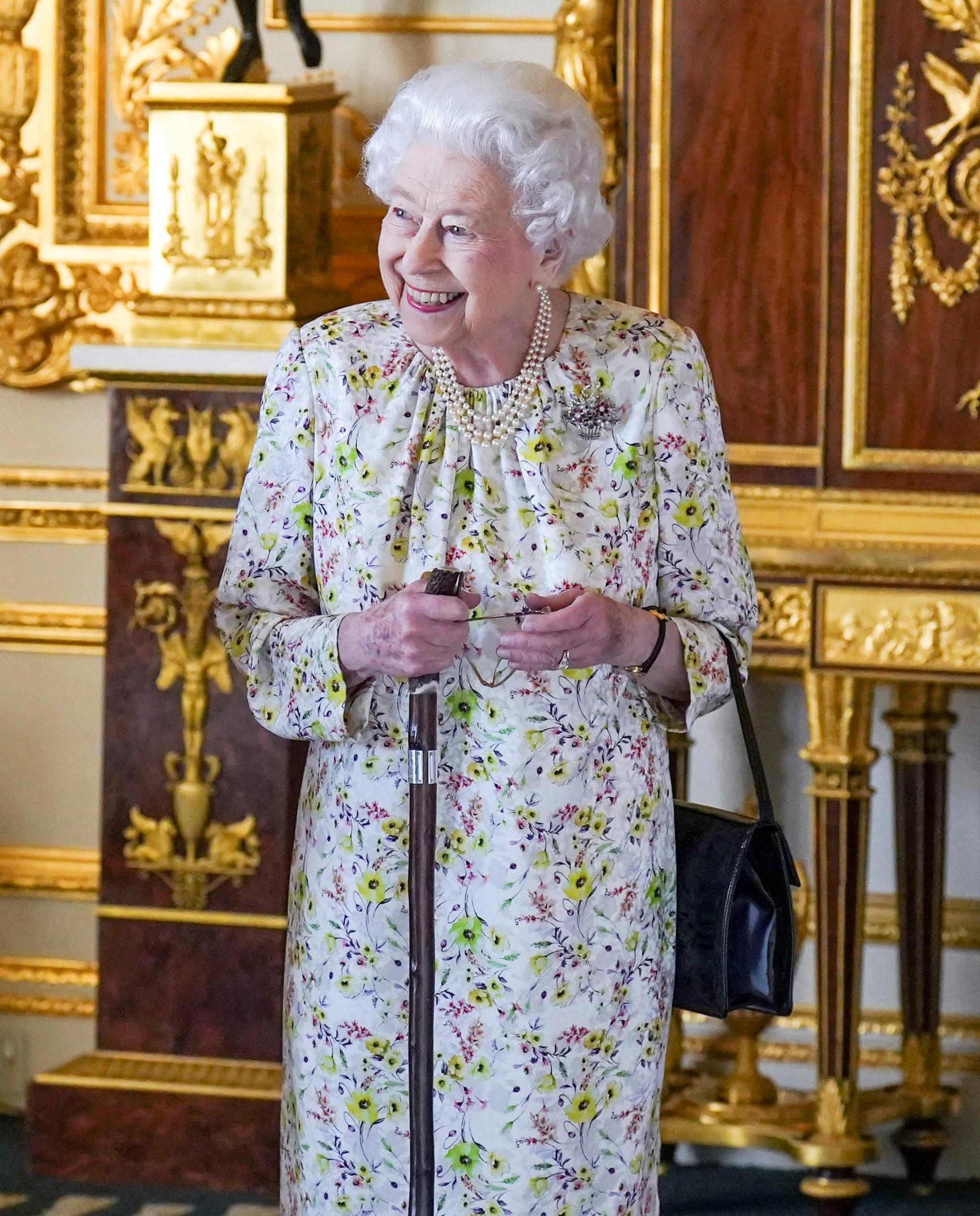The Queen smiles as she arrives to view a display of artefacts from British craftwork company