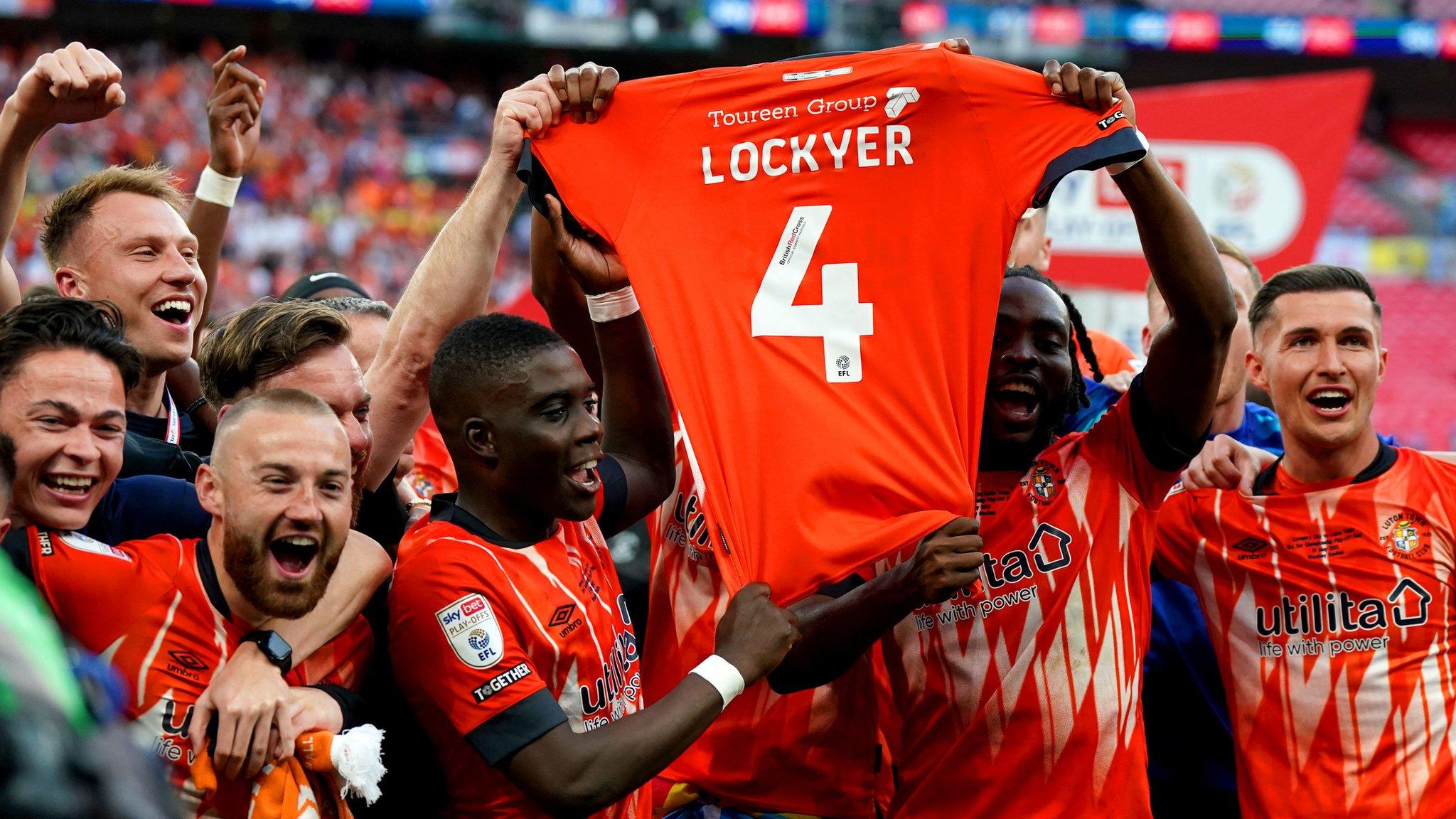 Luton players lift Tom Lockyer's shirt