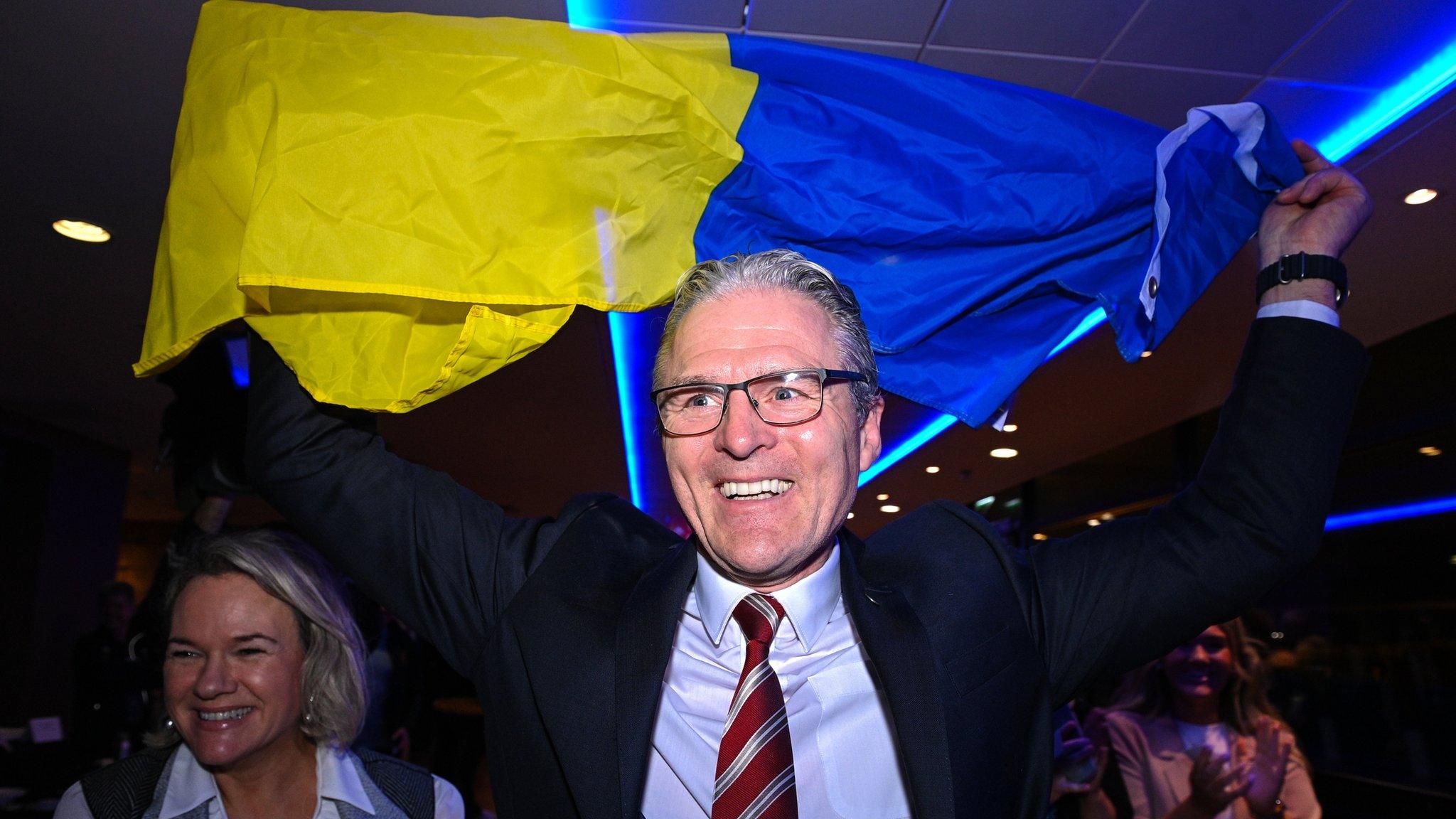 Jarlath Burns holds aloft the flag of his club Silverbridge after being elected as GAA president last year