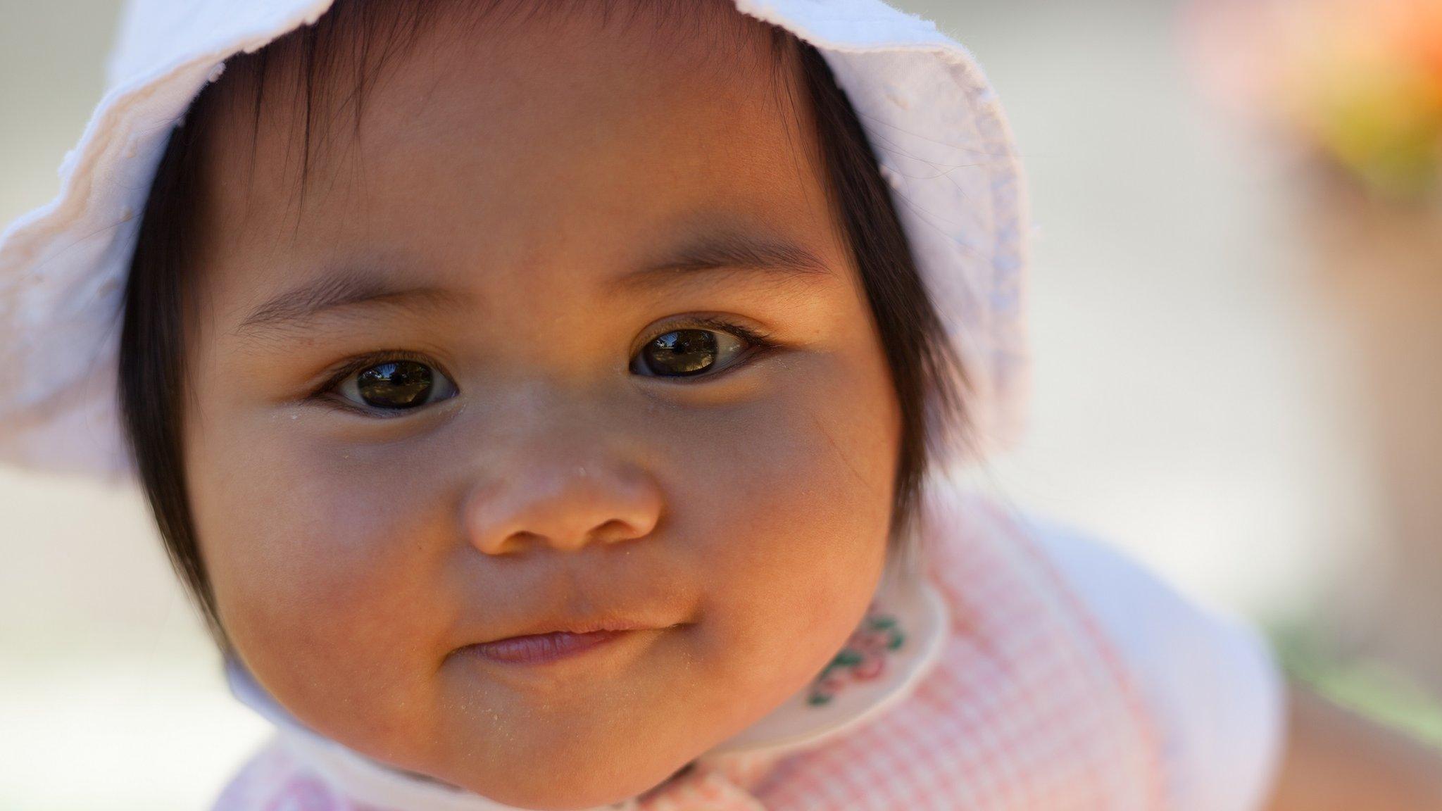 Baby girl in a pink hat