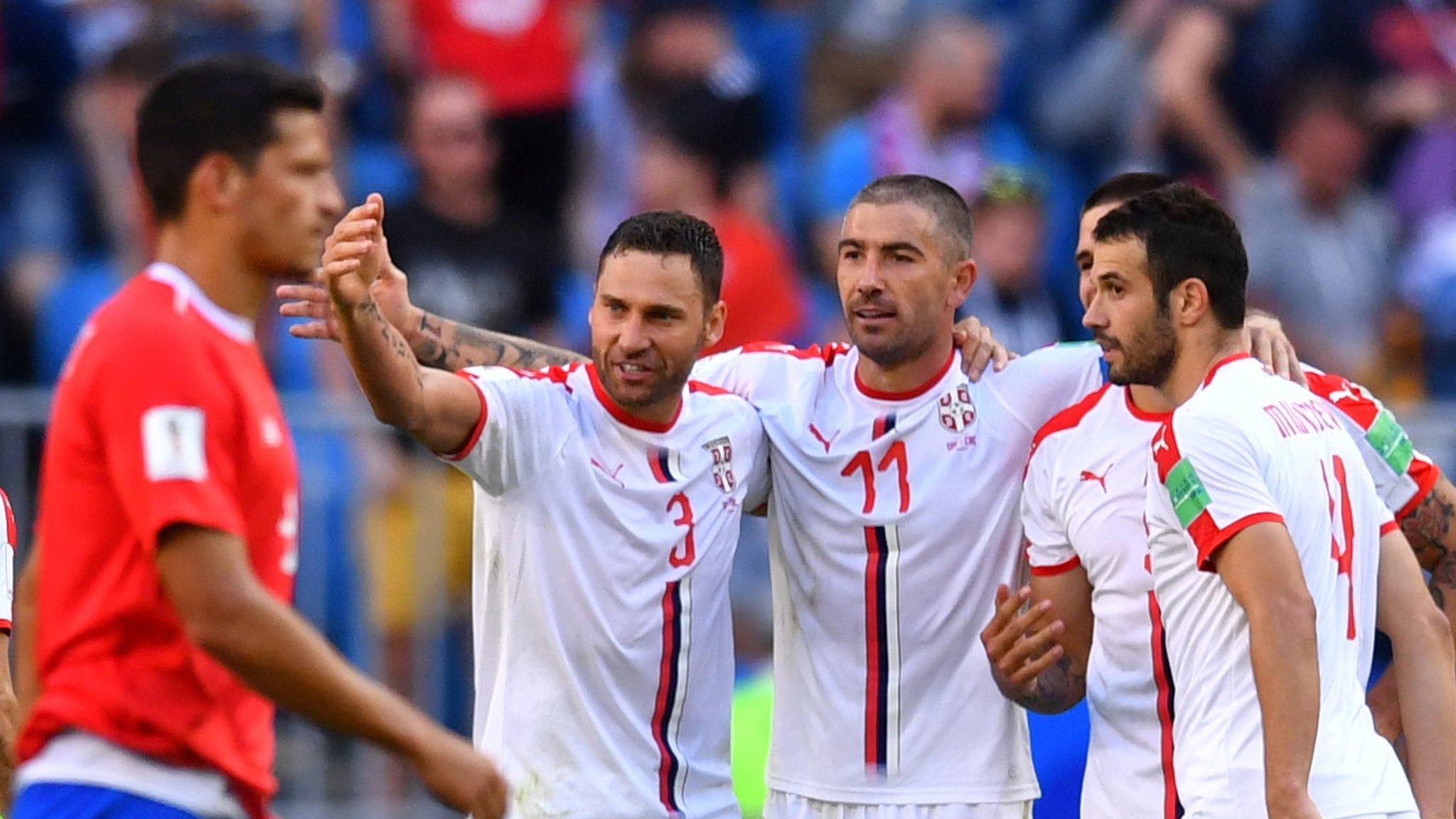 Serbia players celebrate Aleksandar Kolarov's goal