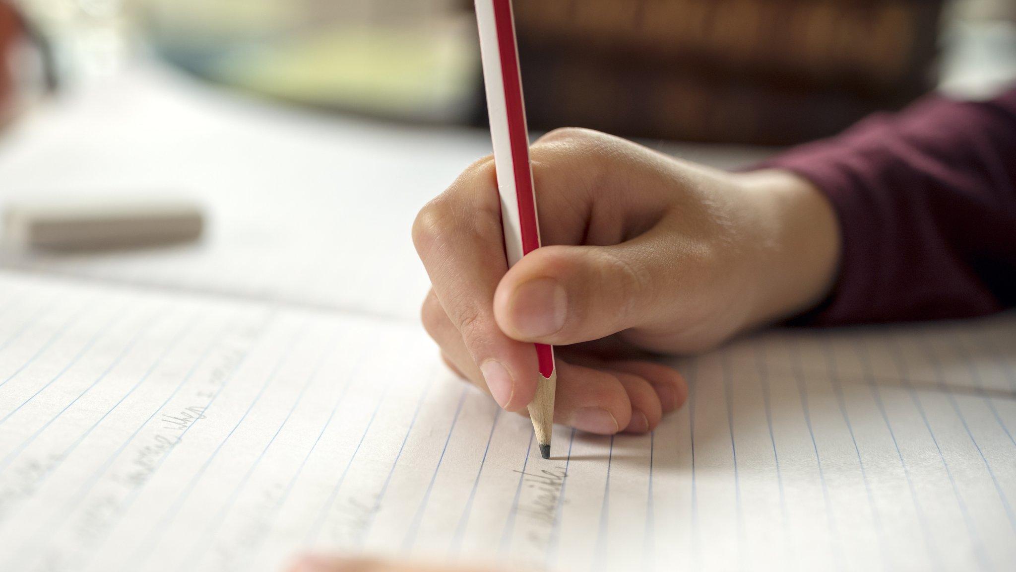 Pupil writing on paper