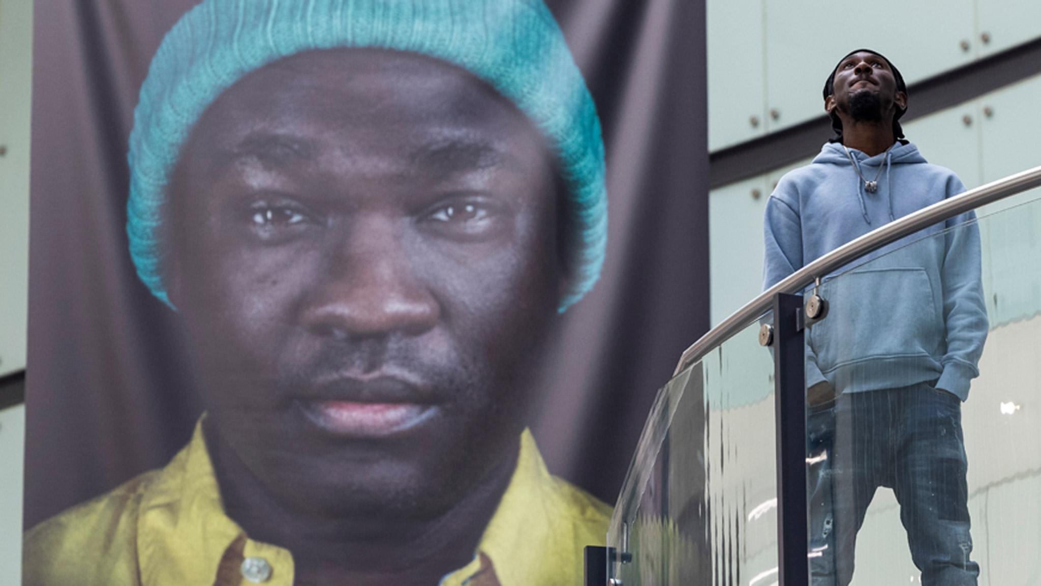 Cephas Williams with one of his photos from the Portrait of Black Britain exhibition at Manchester's Arndale Centre