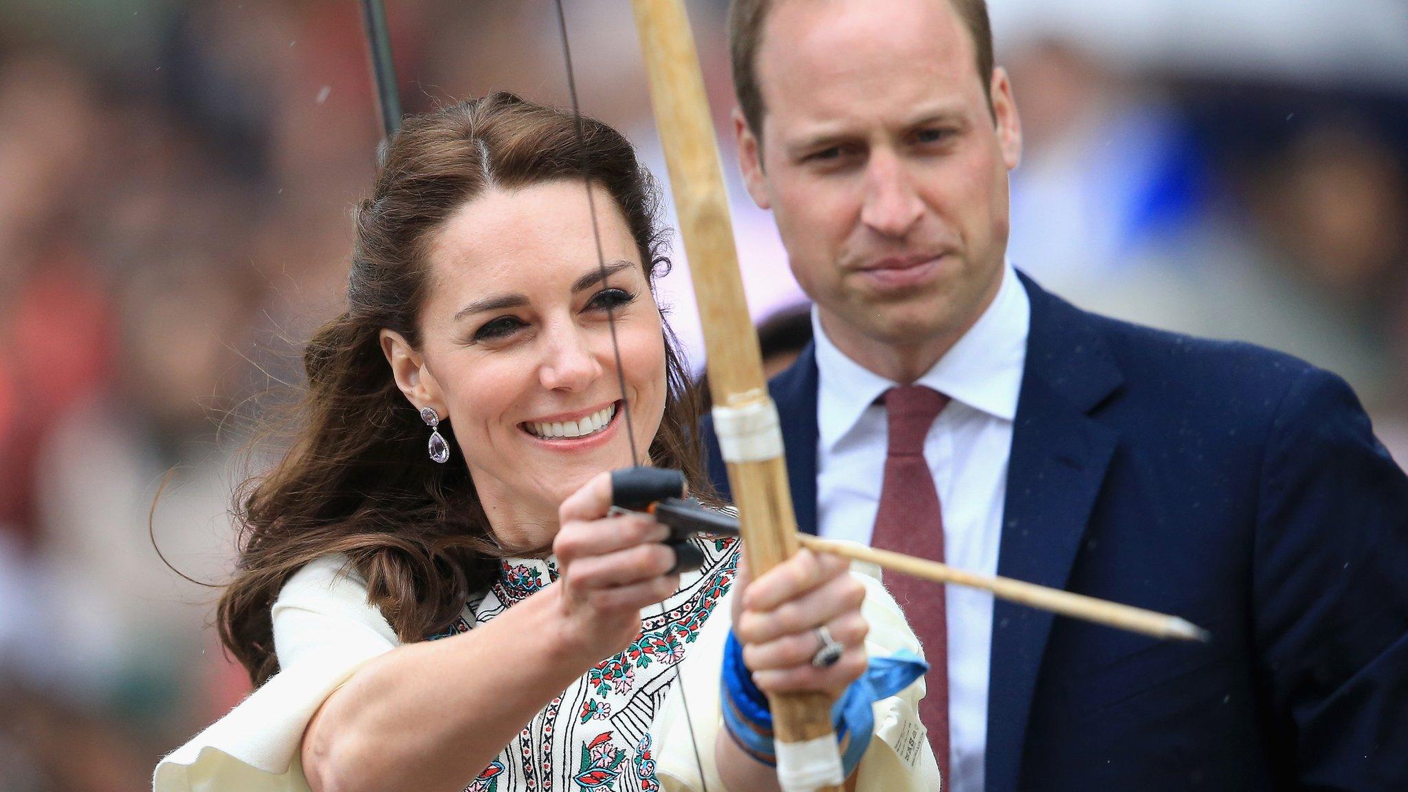 Prince William watches as Duchess of Cambridge fires an arrow during an Bhutanese archery demonstration