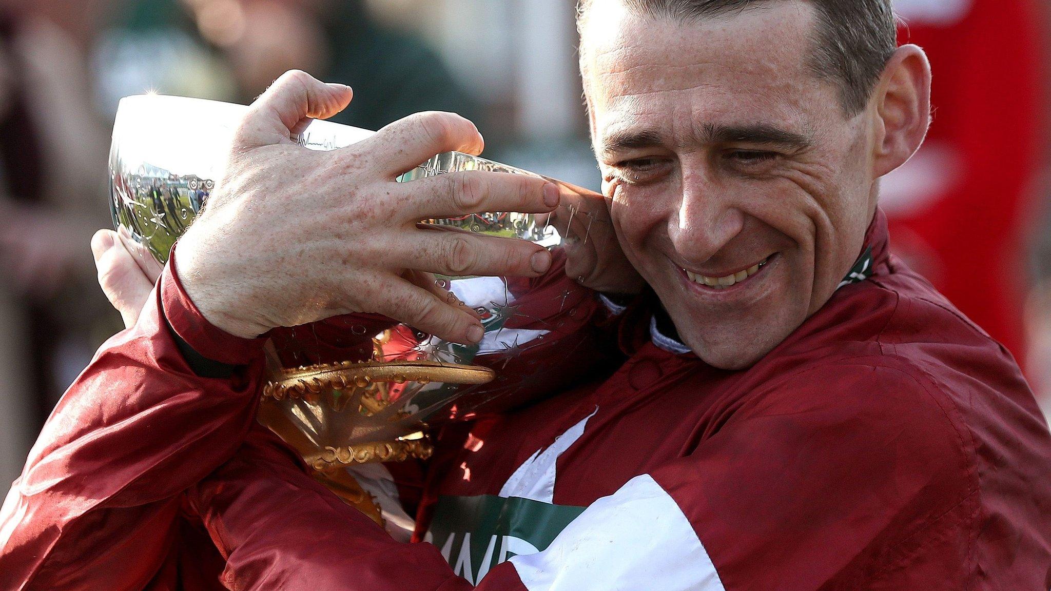 Winning jockey Davy Russell clutches the Grand National trophy