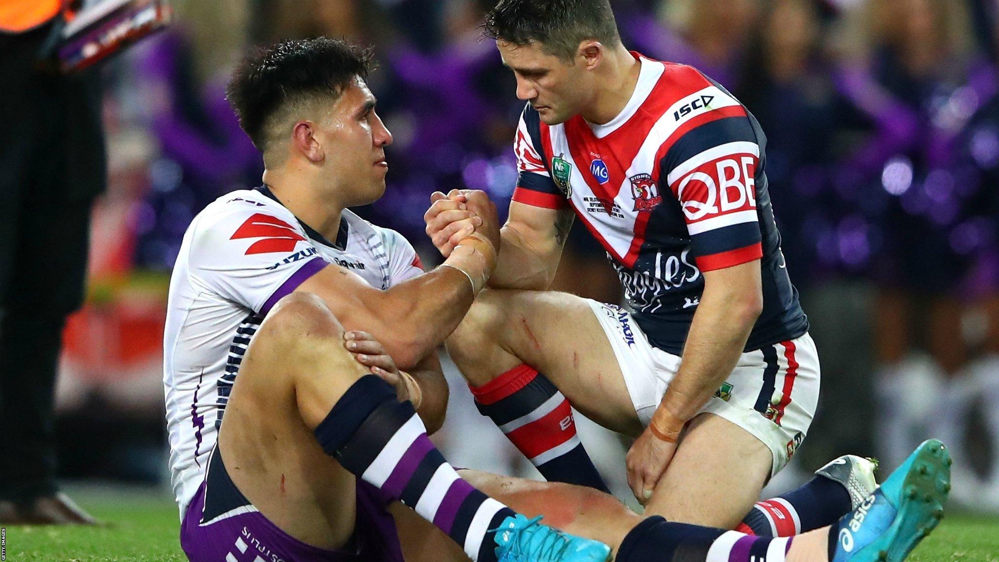 Sydney, Australia, September 30: Cooper Cronk, of Sydney Roosters, consoles Nelson Asofa-Solomona, of Melbourne Storm, after the Roosters beat Storm 21-6 in the 2018 NRL Grand Final. (Photo by Cameron Spencer/Getty Images)