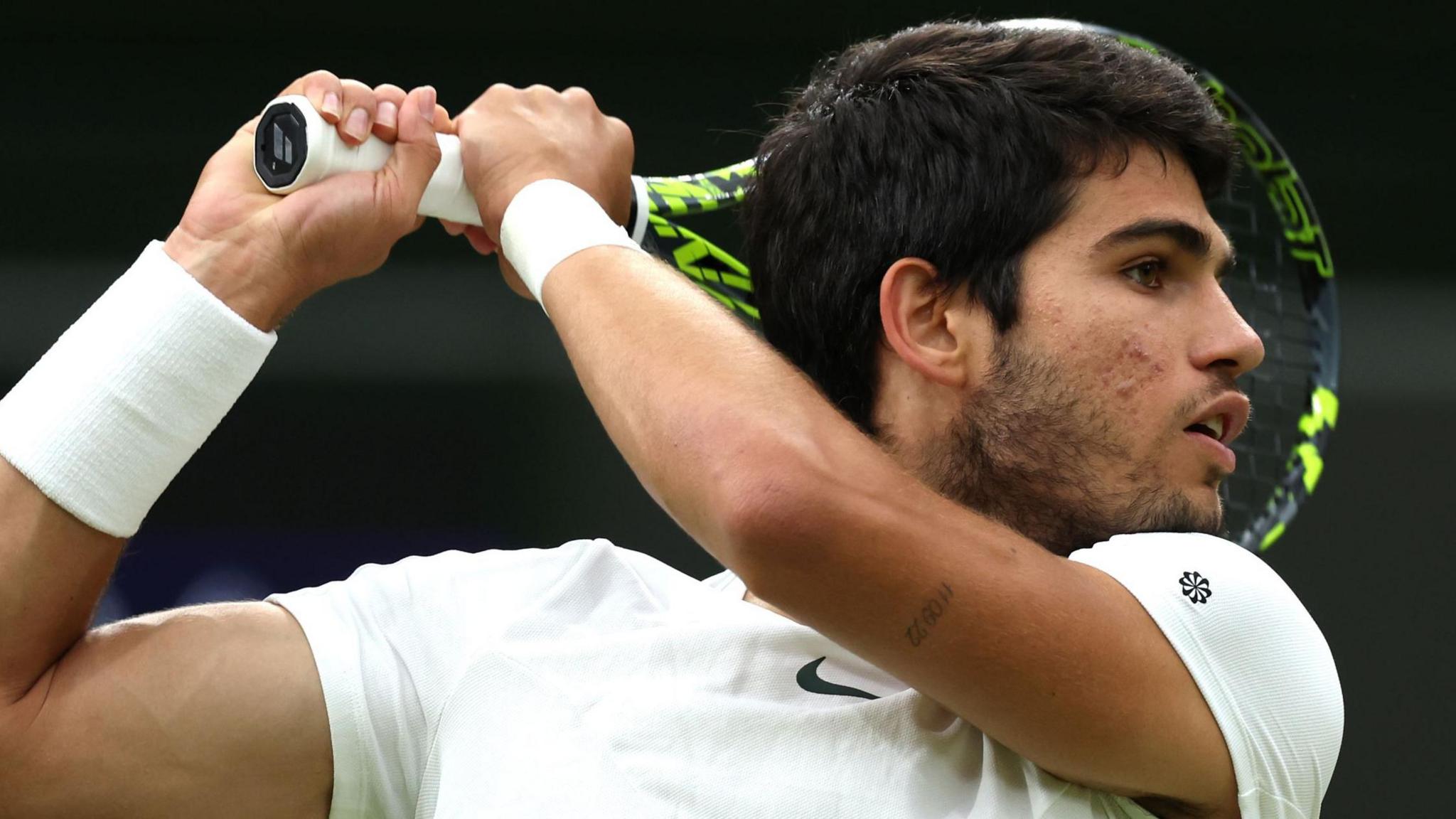 Carlos Alcaraz hits a backhand at Wimbledon in 2023