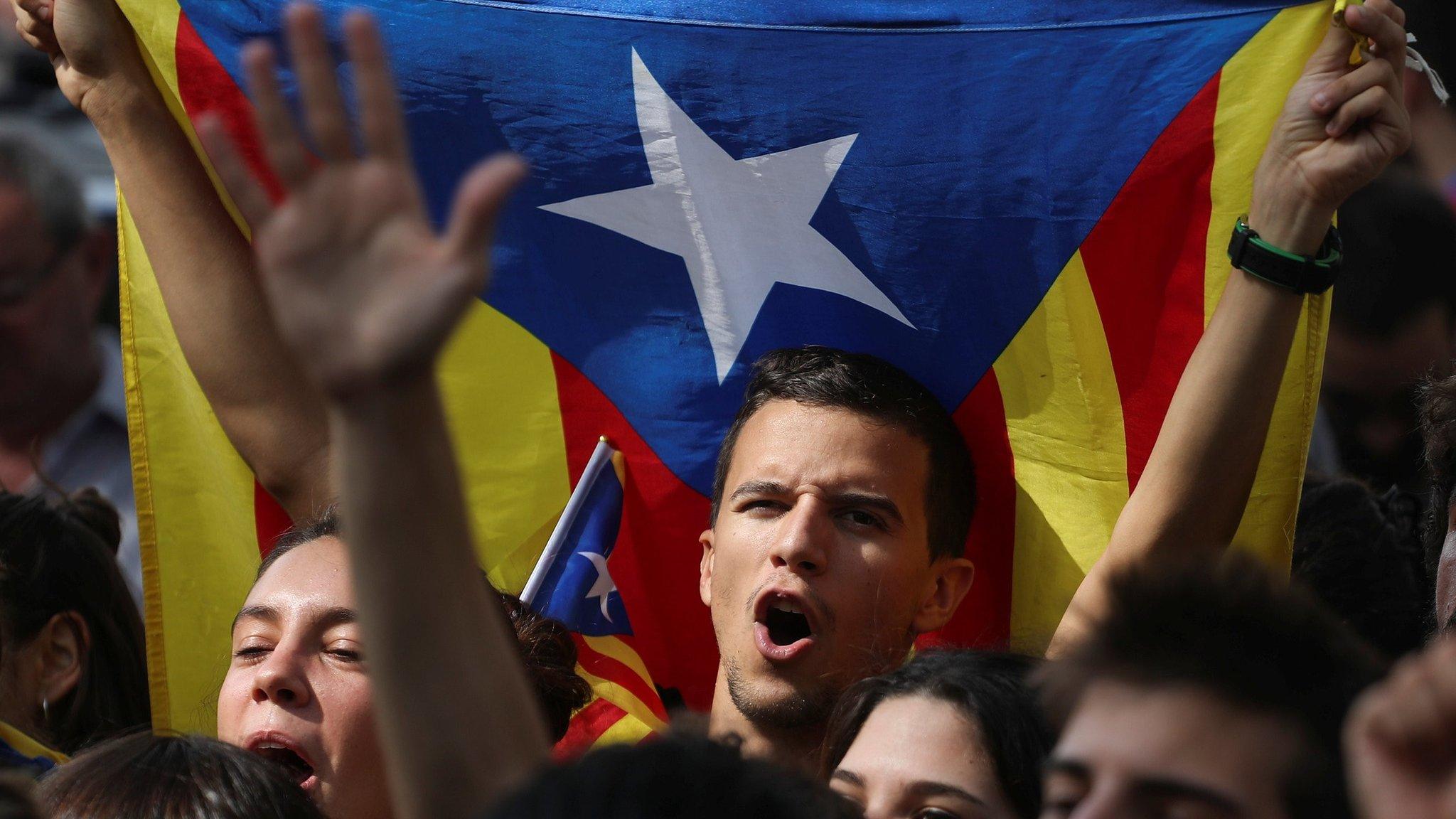 Protesters shout slogans and wave Esteladas (Catalan separatist flags) as they gather outside the High Court of Justice of Catalonia in Barcelona, Spain, 21 September 2017