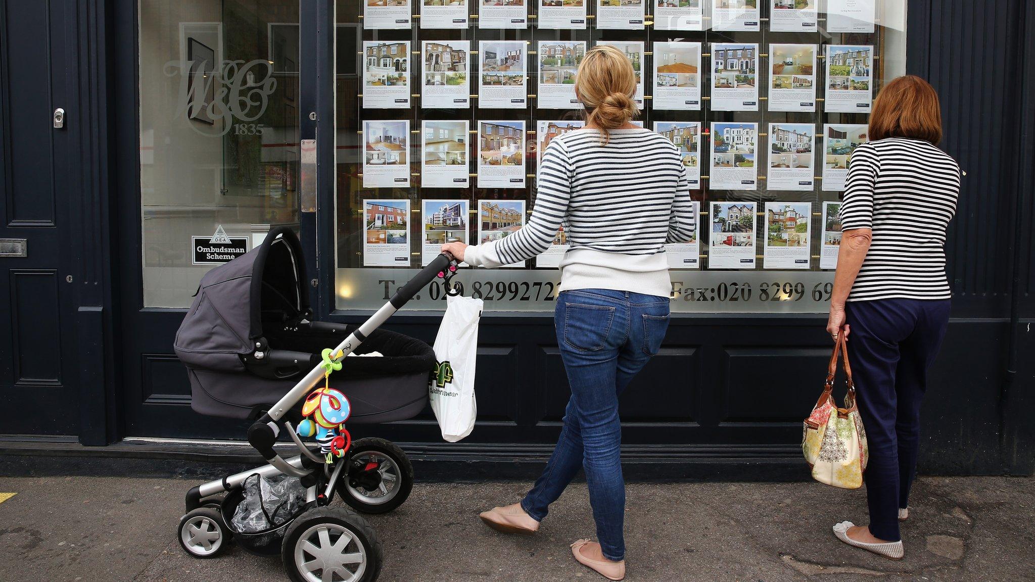 Two women browse at Estate Agent