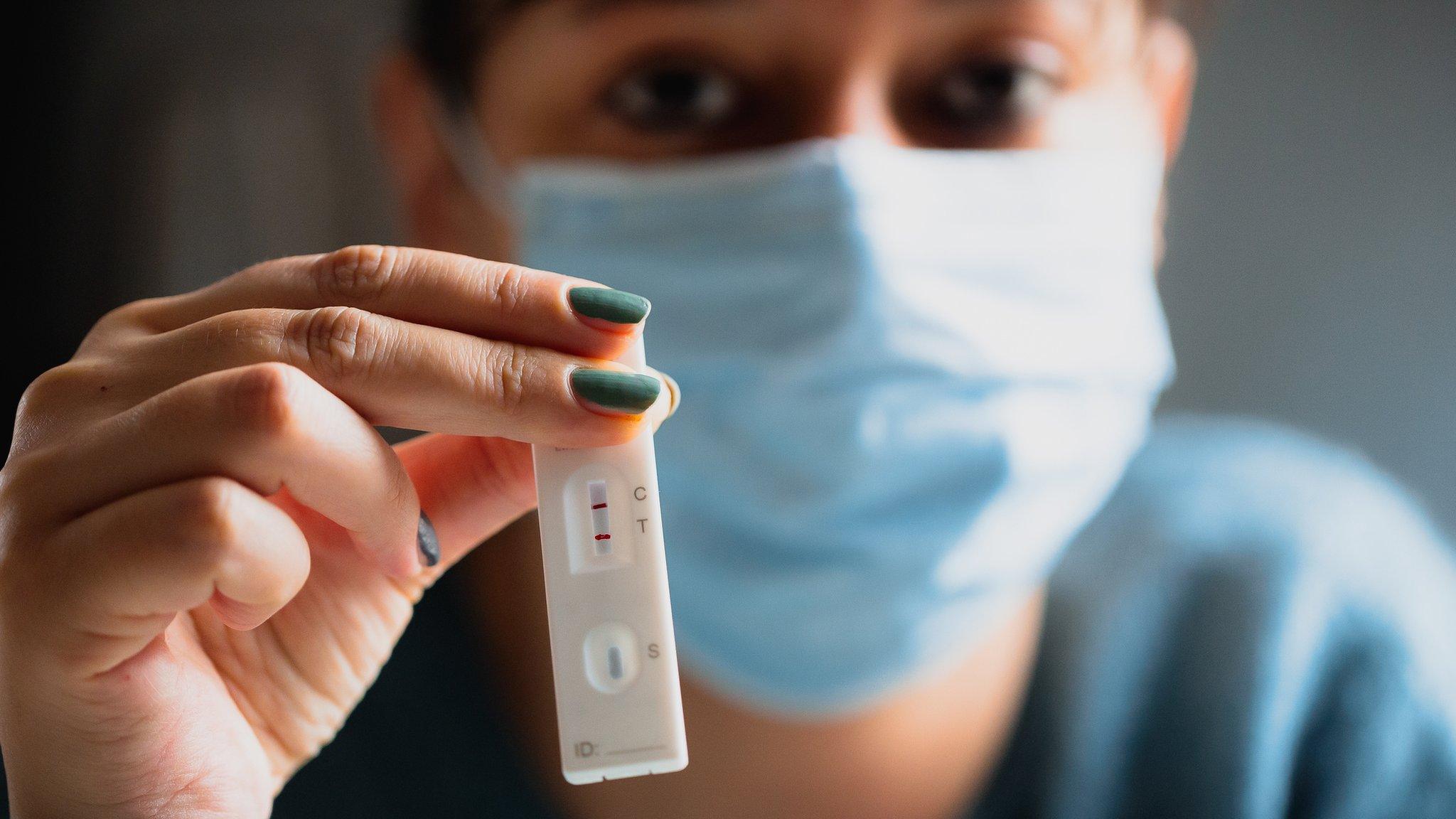 Woman holding positive lateral flow test