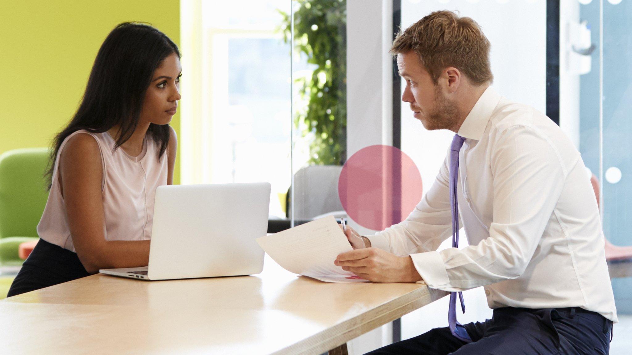 A woman and man talk at work