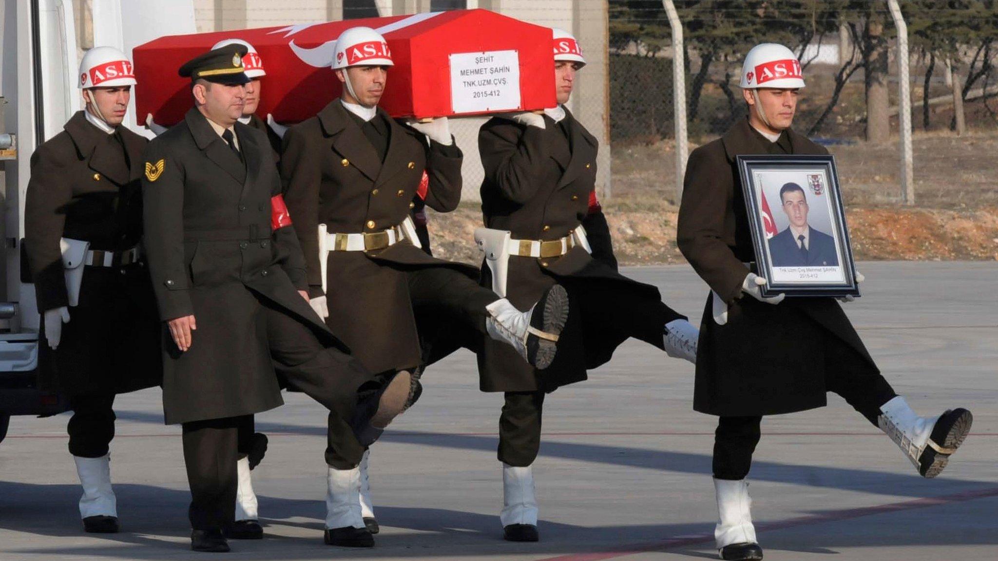 Turkish soldiers carry a comrade killed in a Russian air strike in northern Syria, at the airport in Gaziantep, south-eastern Turkey (10 February 2017)