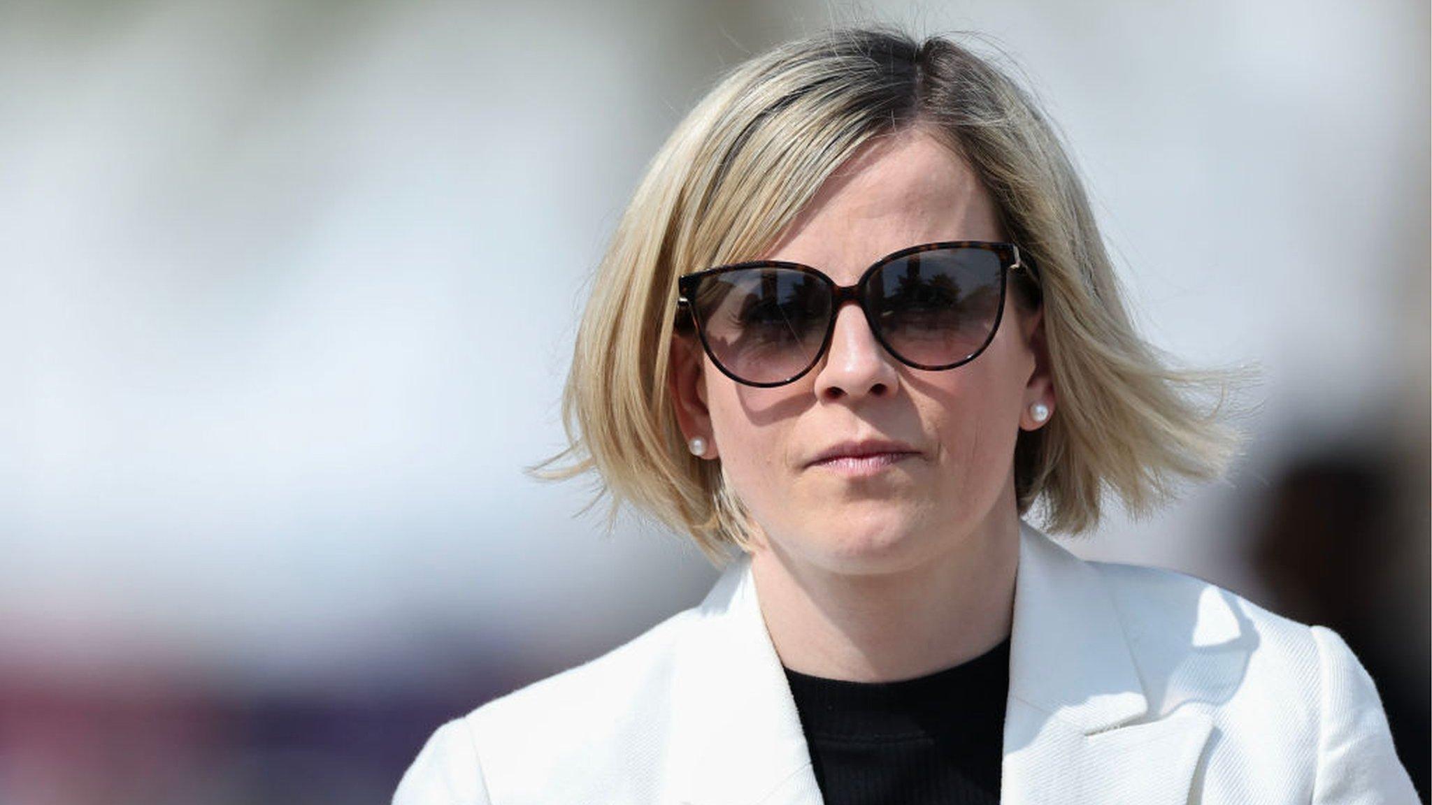 Susie Wolff looks ahead wearing sunglasses