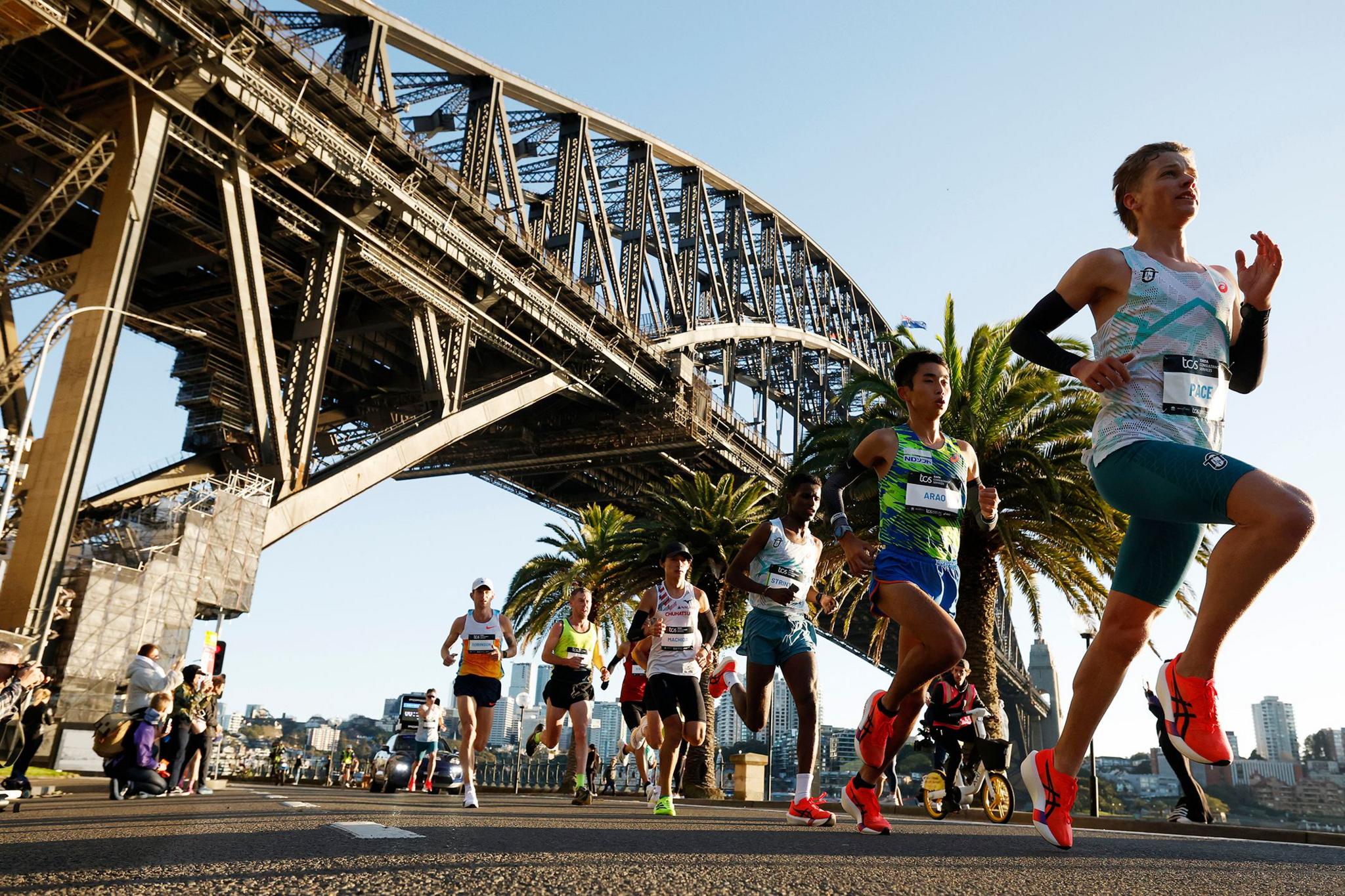 Runners pass under the Sydney Harbour Bridge during the 2025 Sydney Marathon. Photo by Darrian Traynor