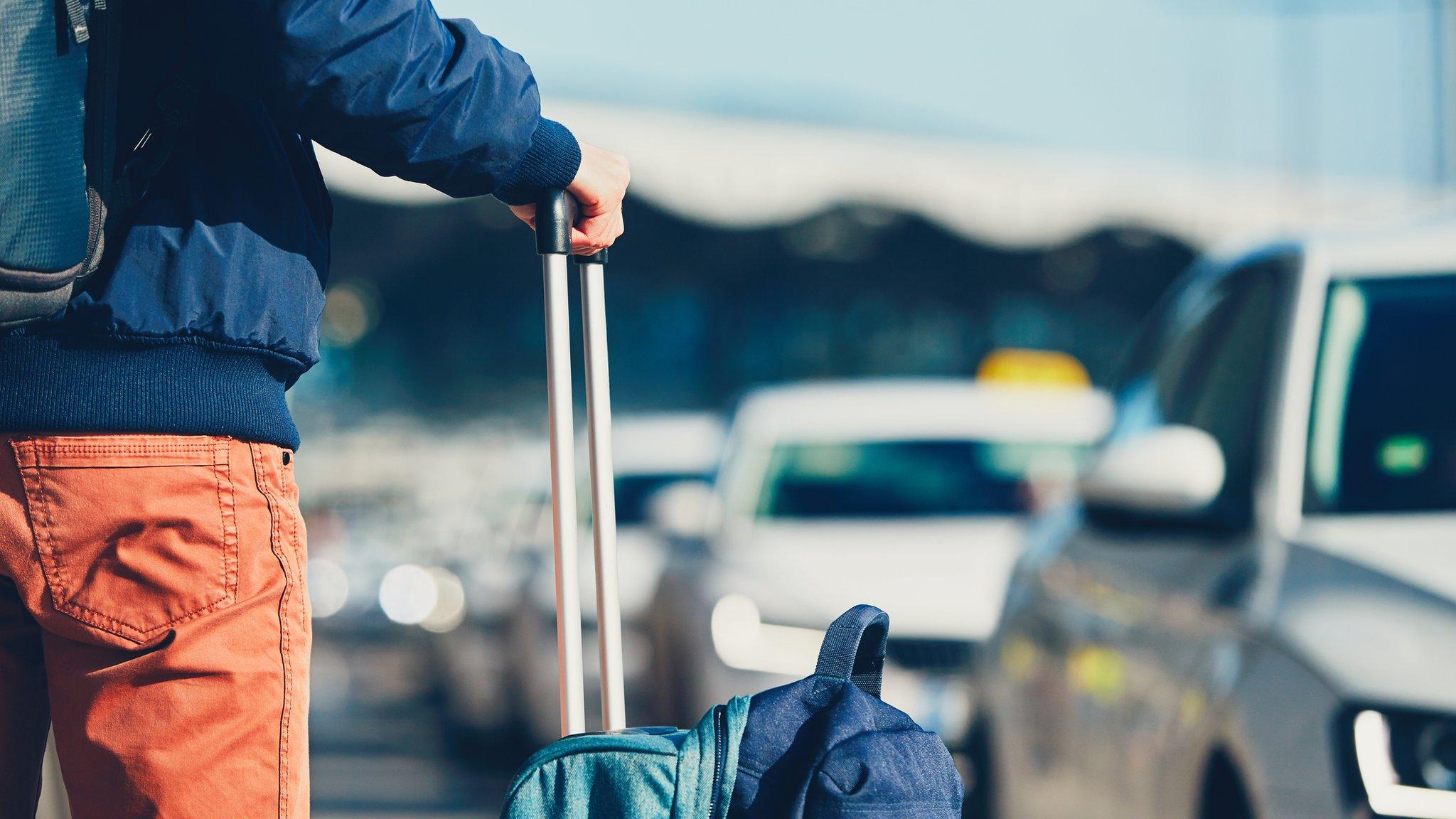 Passenger with suitcases at airport