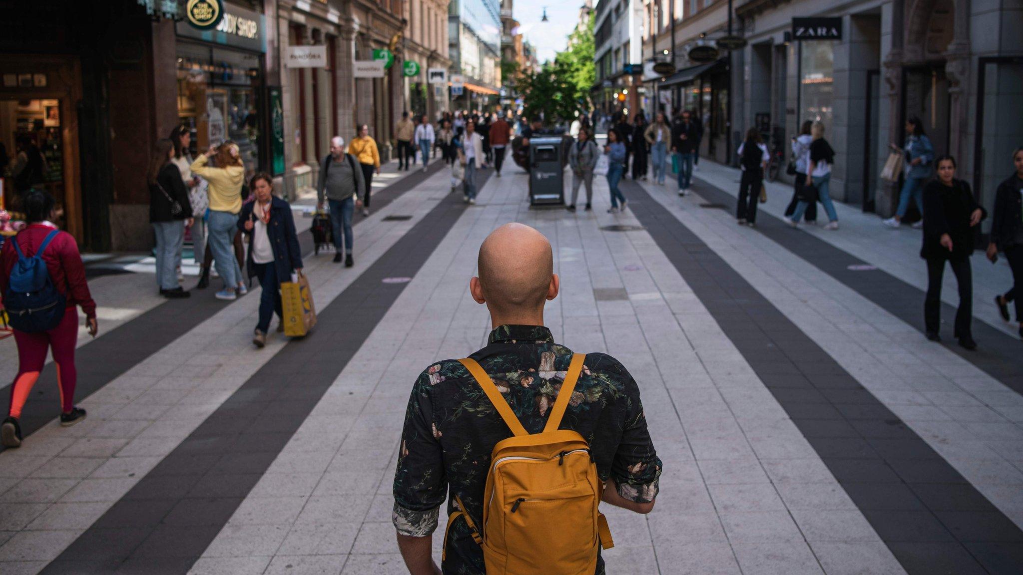 People walk in Drottninggatan in Stockholm on May 29, 2020,