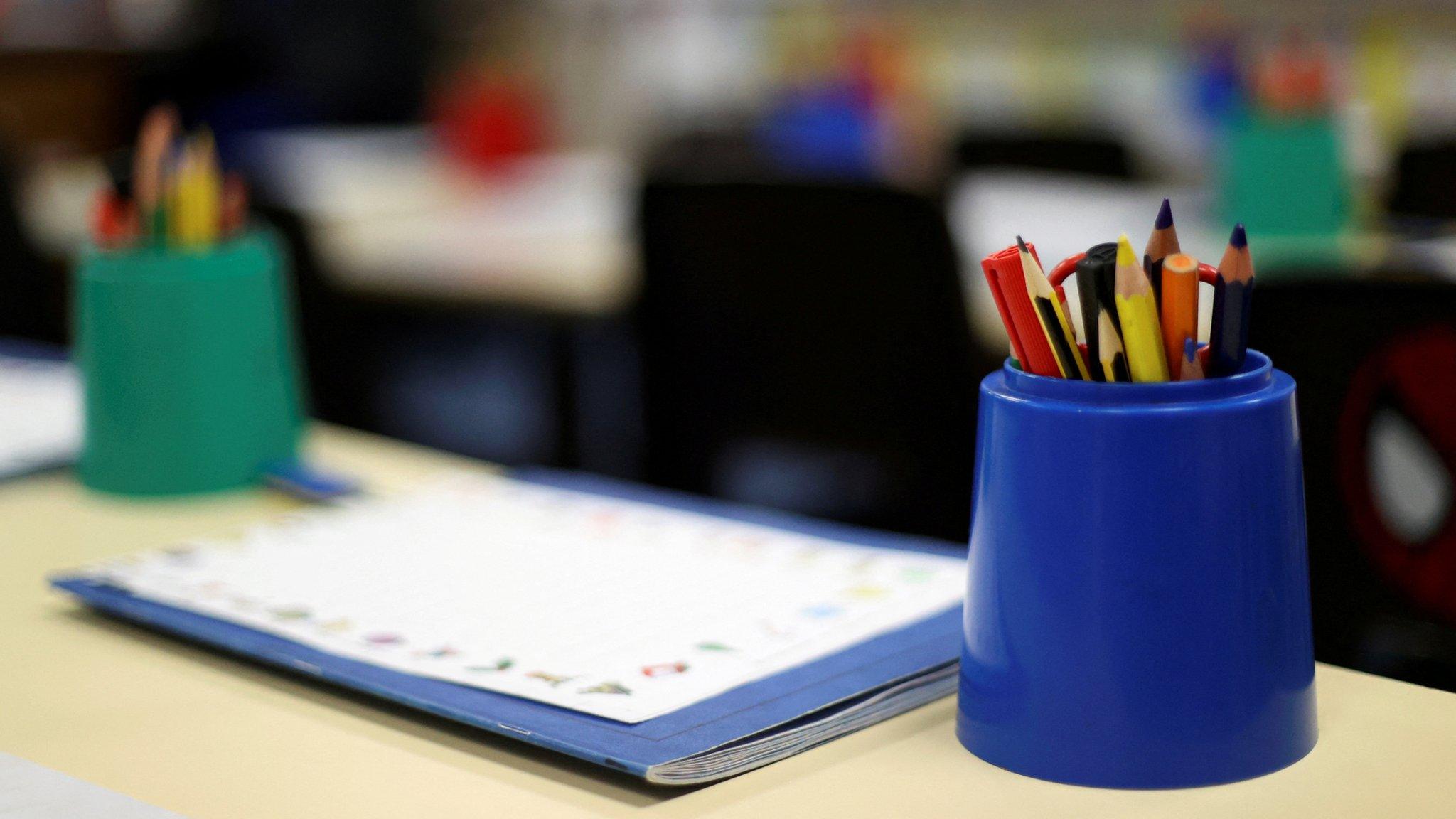 Pencils in holders in an empty classroom