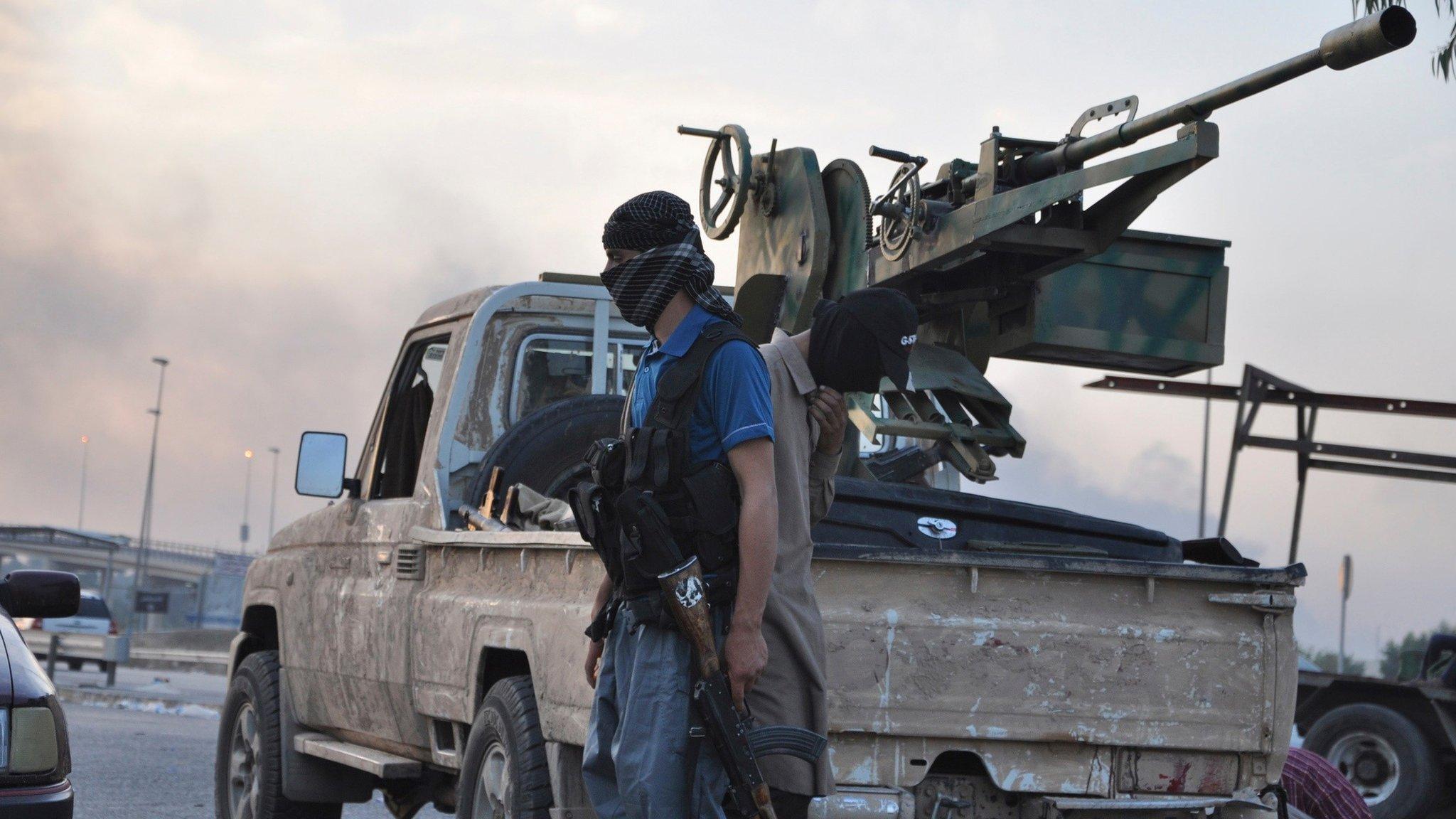 Islamic State militants at a checkpoint in Mosul (12 June 2014)