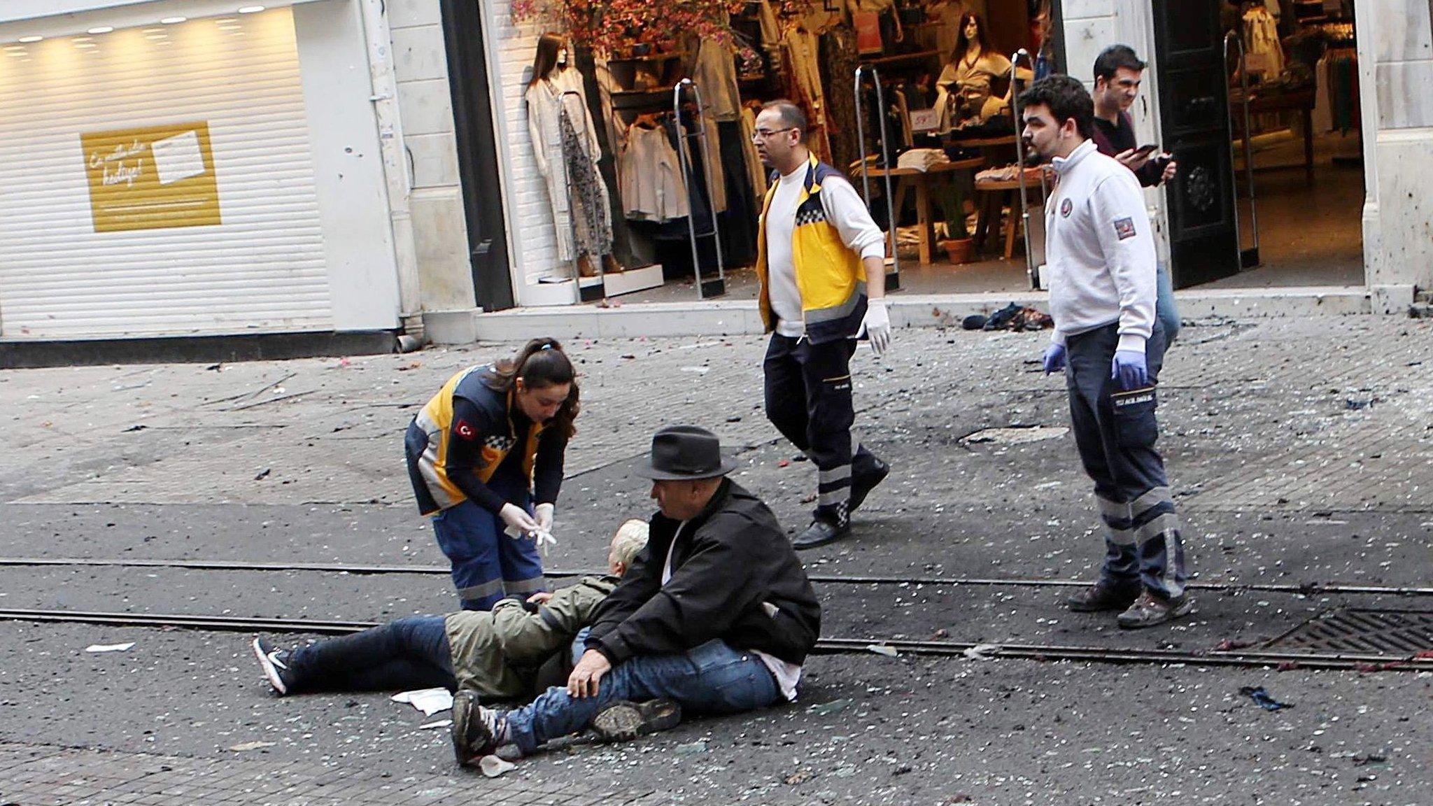 Medics try to help wounded people after an explosion in Istiklal Street in Istanbul