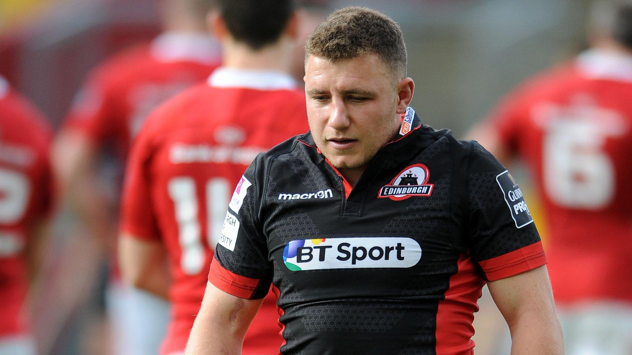 Edinburgh fly-half Duncan Weir leaves the Munster pitch after sustaining a head knock