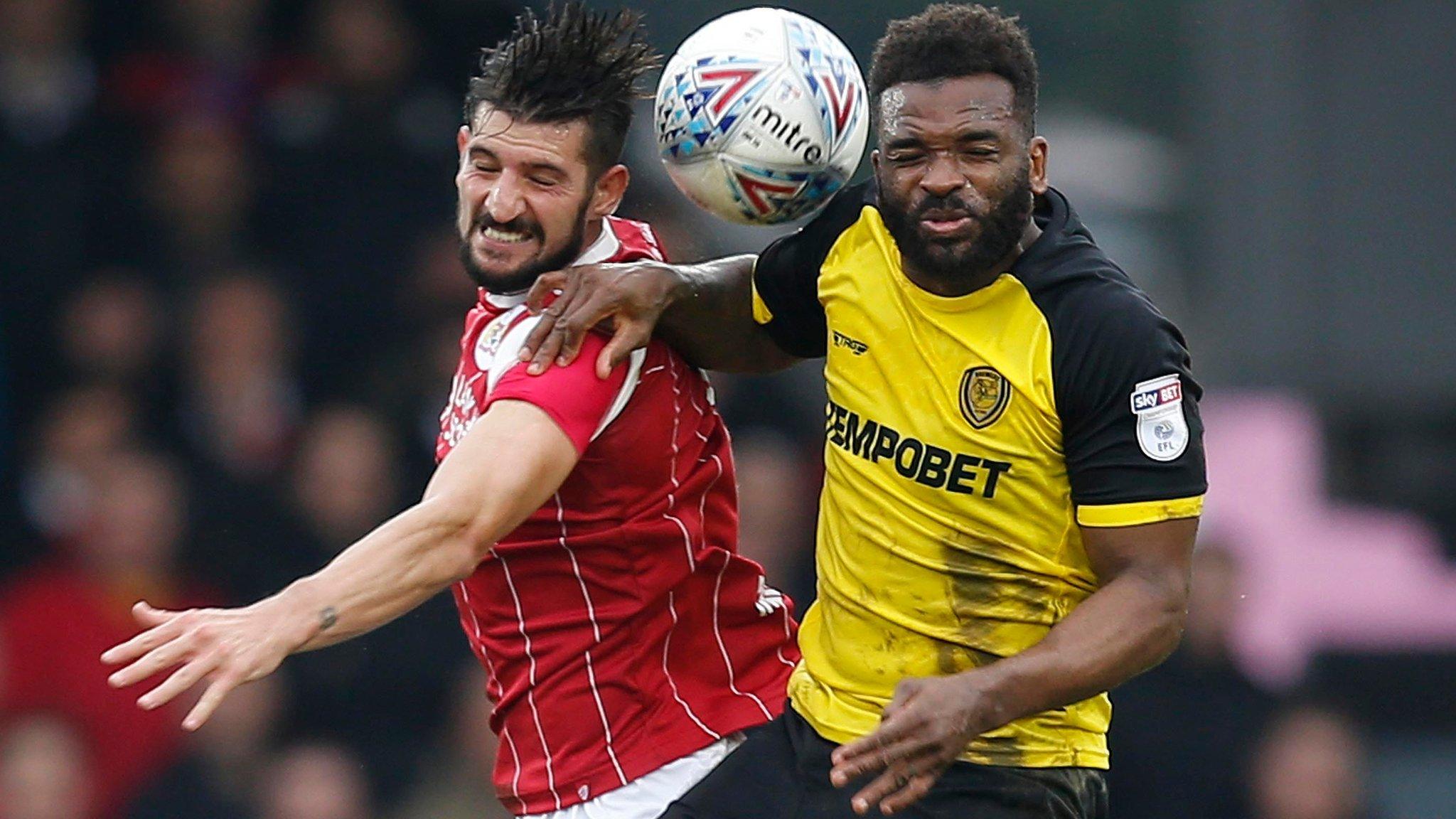 Bristol City's Eros Pisano (left) and Darren Bent of Burton Albion tussle for possession