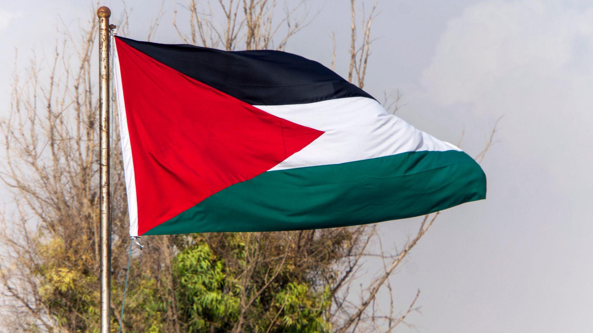 Palestinian flag on the top of building