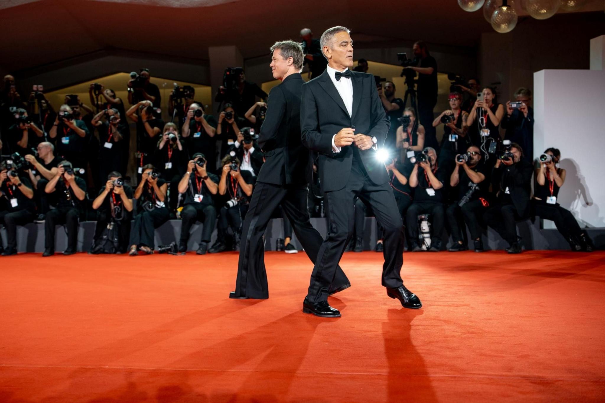 Brad Pitt and George Clooney dance on the red carpet