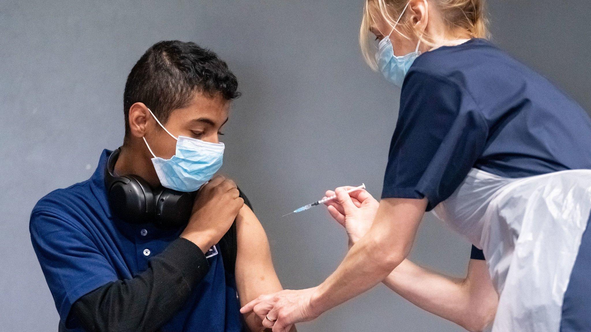 Nurse Sonia Wilson (right) vaccinates eighteen-year-old Cameron Ladd (left) with the Pfizer Covid-19 vaccination, at a mass coronavirus vaccination centre at Adwick Leisure Centre, in Doncaster