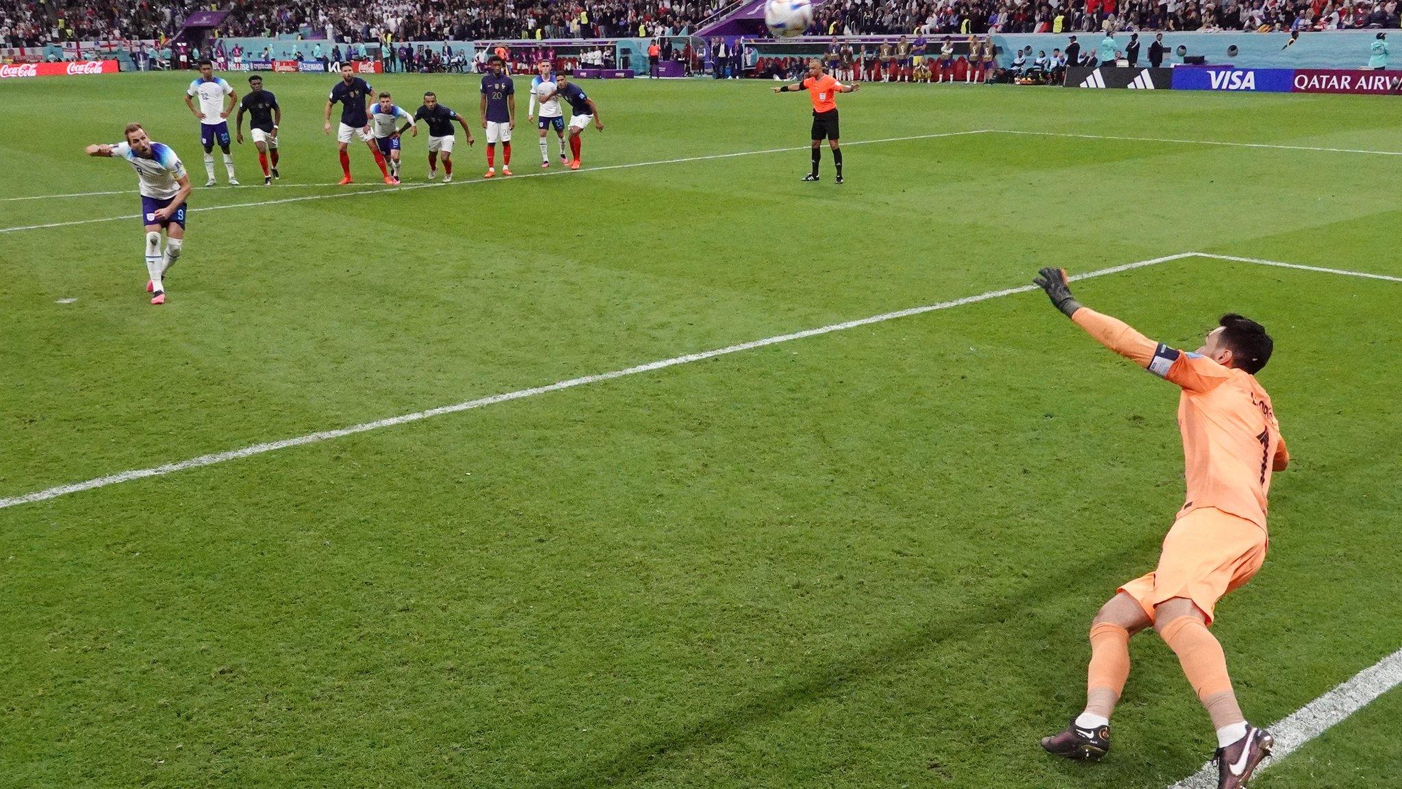 A shot from inside the goal of Harry Kane skying his penalty, with goalkeeper Hugo Lloris diving in the foreground and players on the edge of the area in the background