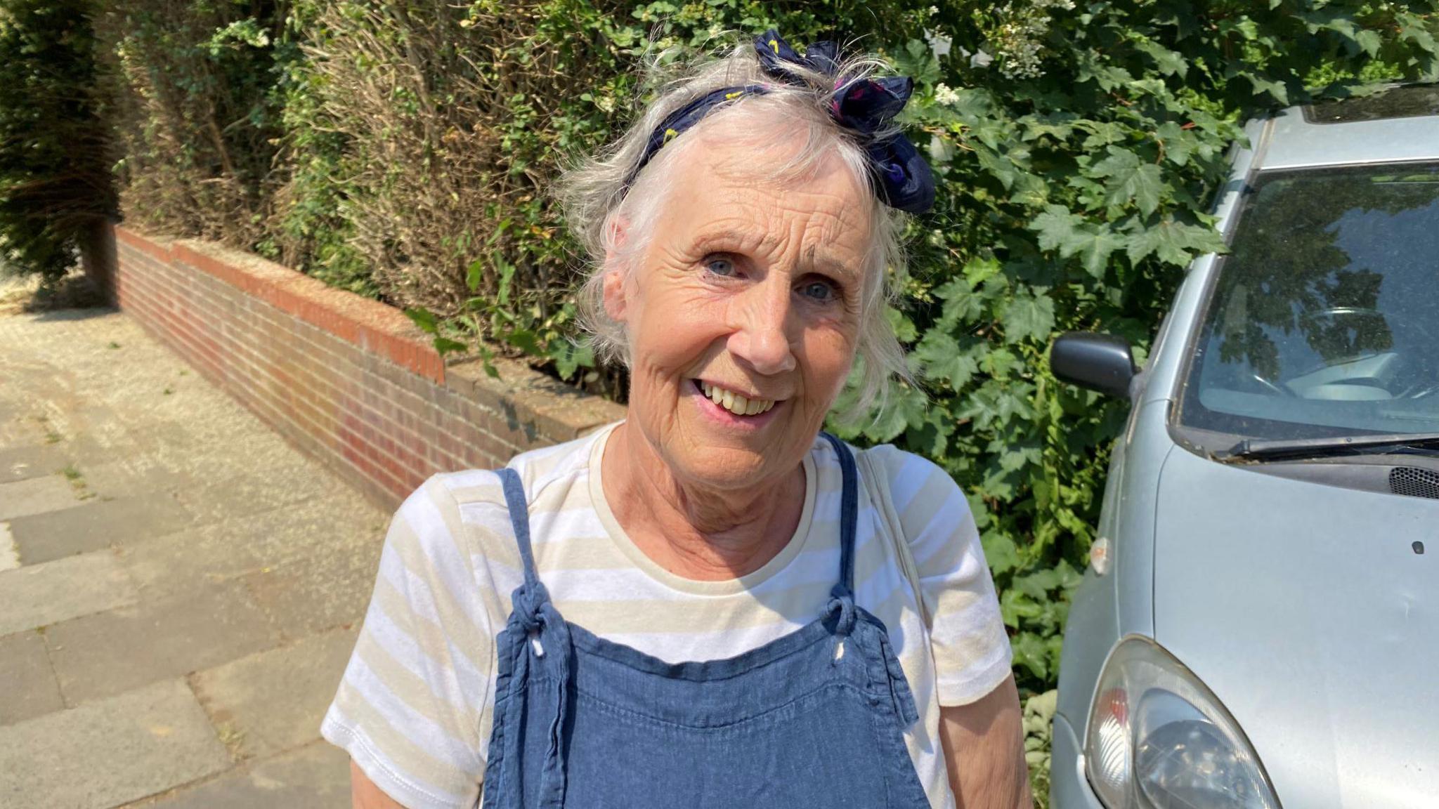 Jo Davis in striped top and blue dungarees 