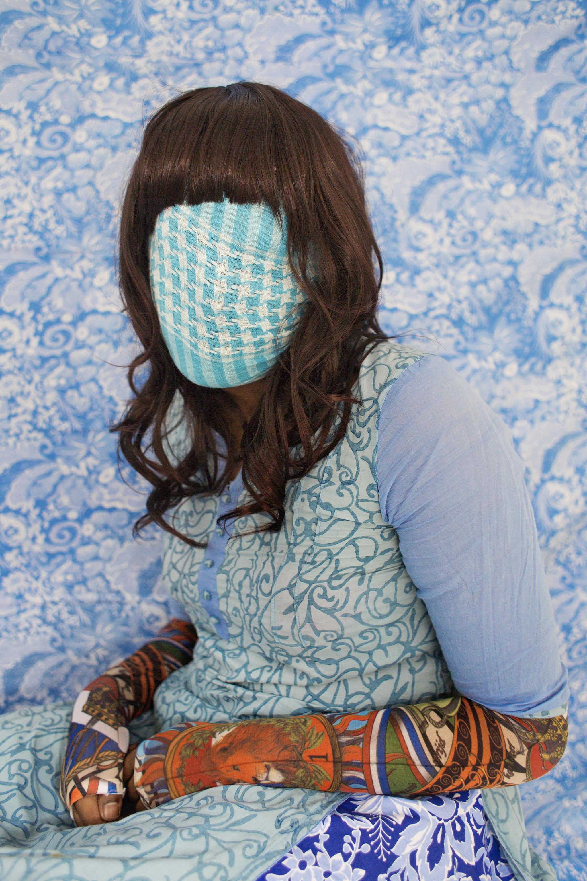 Bangladeshi woman with face covered by blue fabric