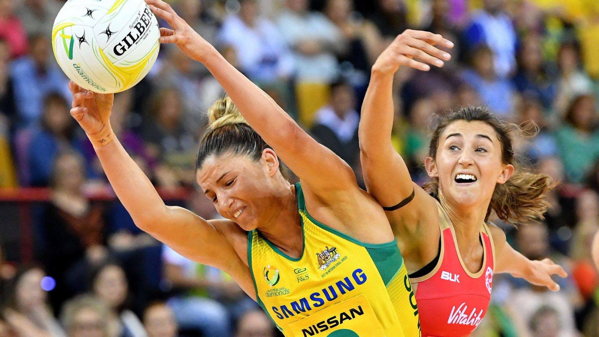 Australia's Kim Ravaillion and Serena Guthrie of England challenge for the ball