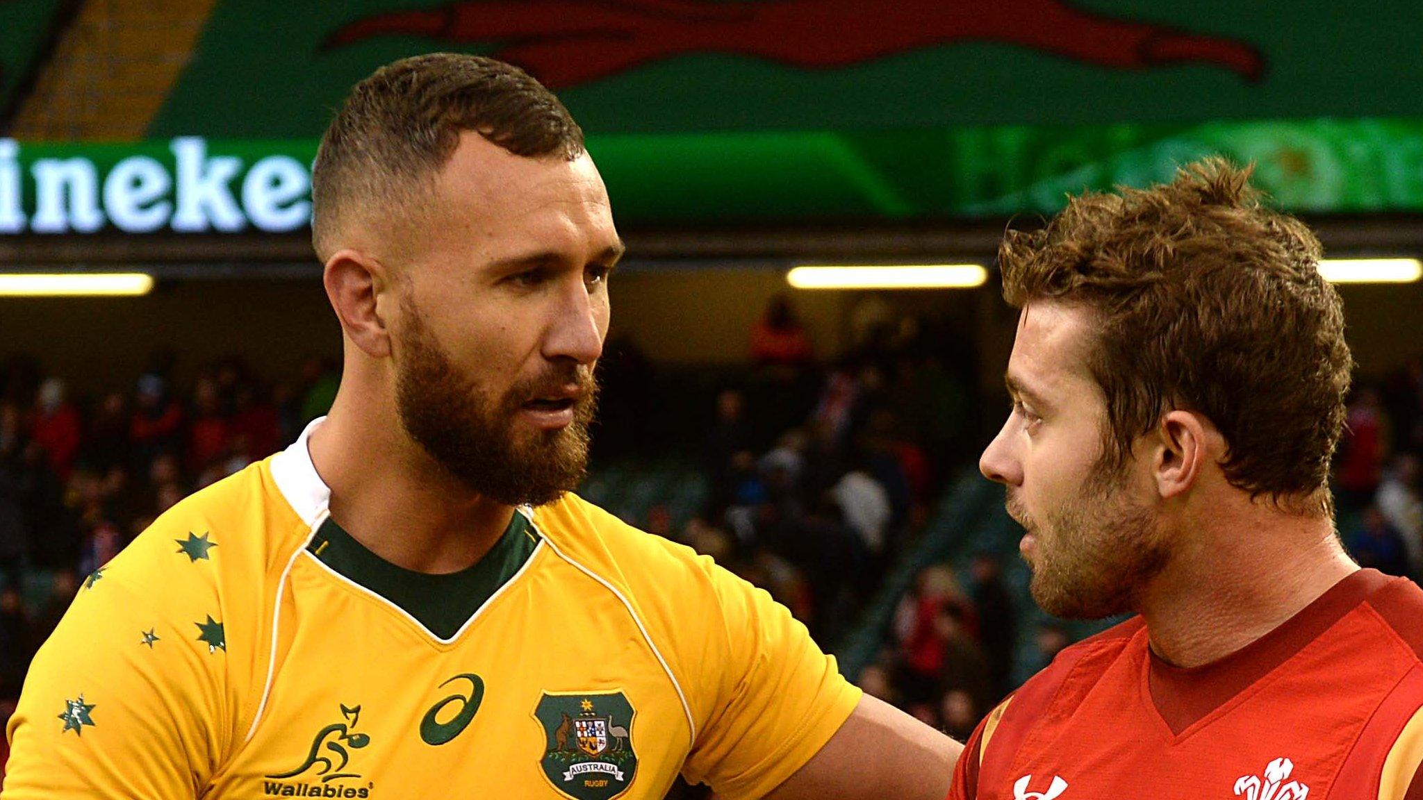 Quade Cooper shakes hands with Wales' Leigh Halfpenny