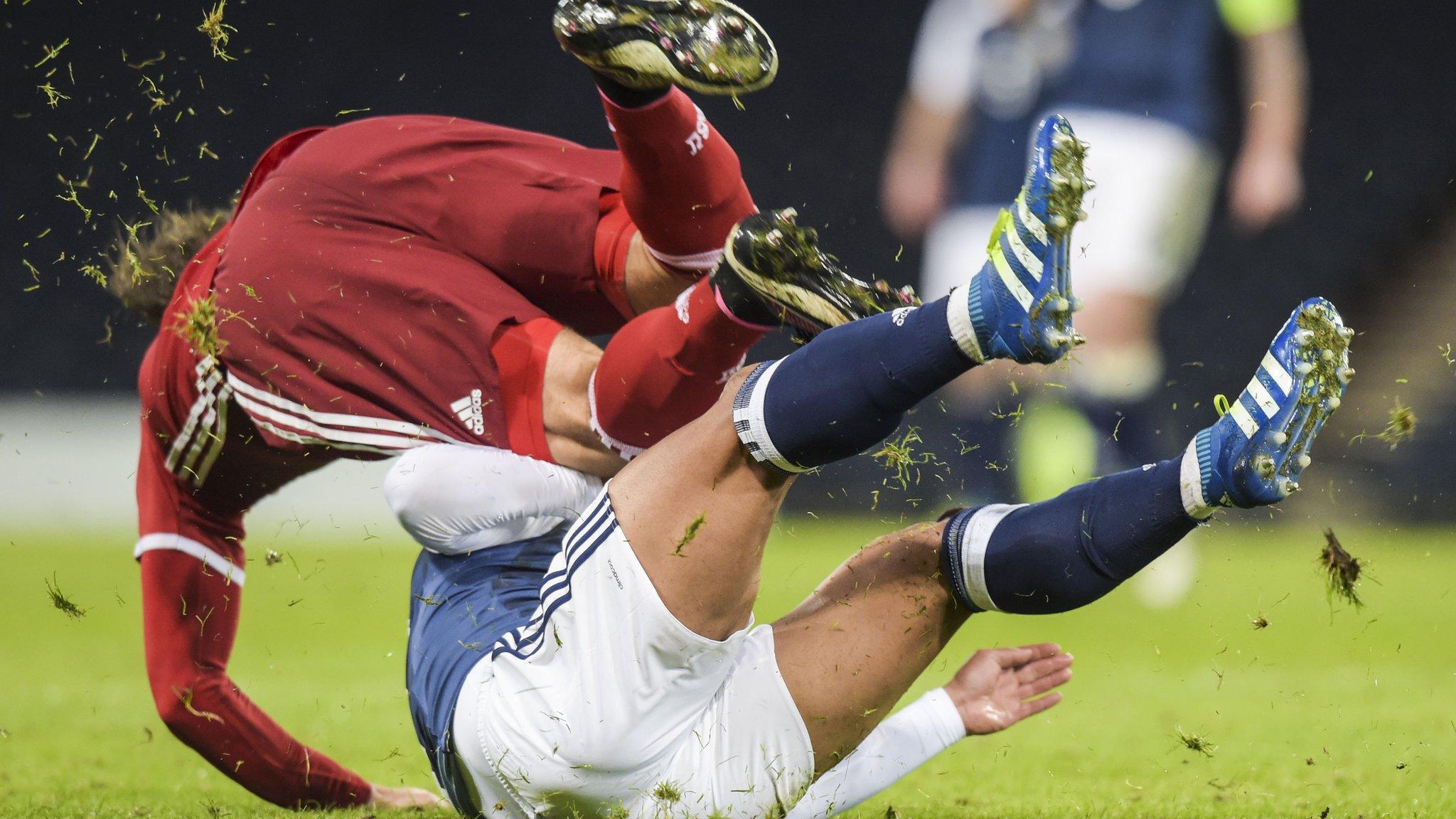 Denmark's Erik Sviatchenko is tackled by Scotland's Liam Bridcutt